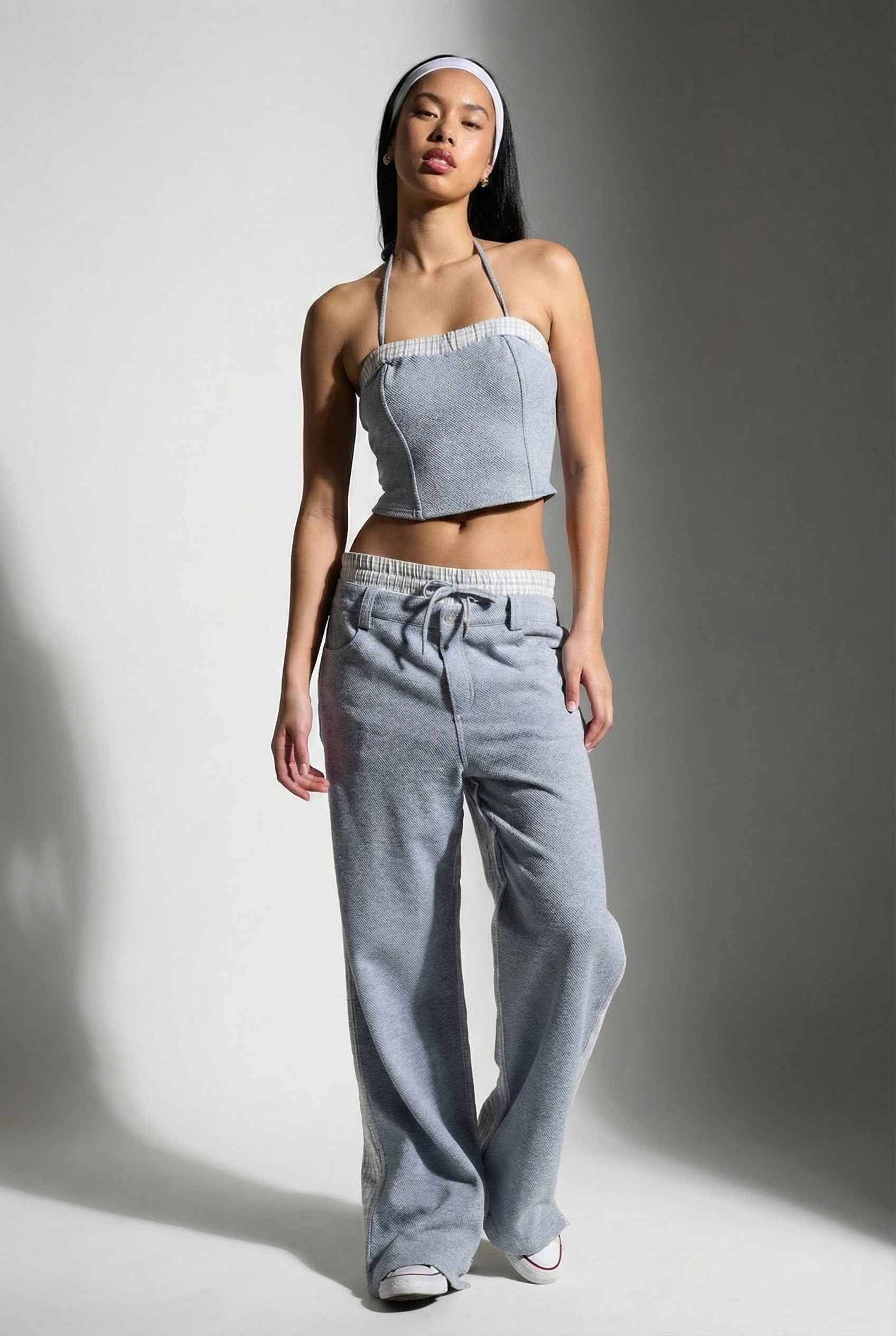 Model wearing Jamie Pants in Blue Double-Waist Boxer Style Trousers with matching halter top and sneakers against plain backdrop