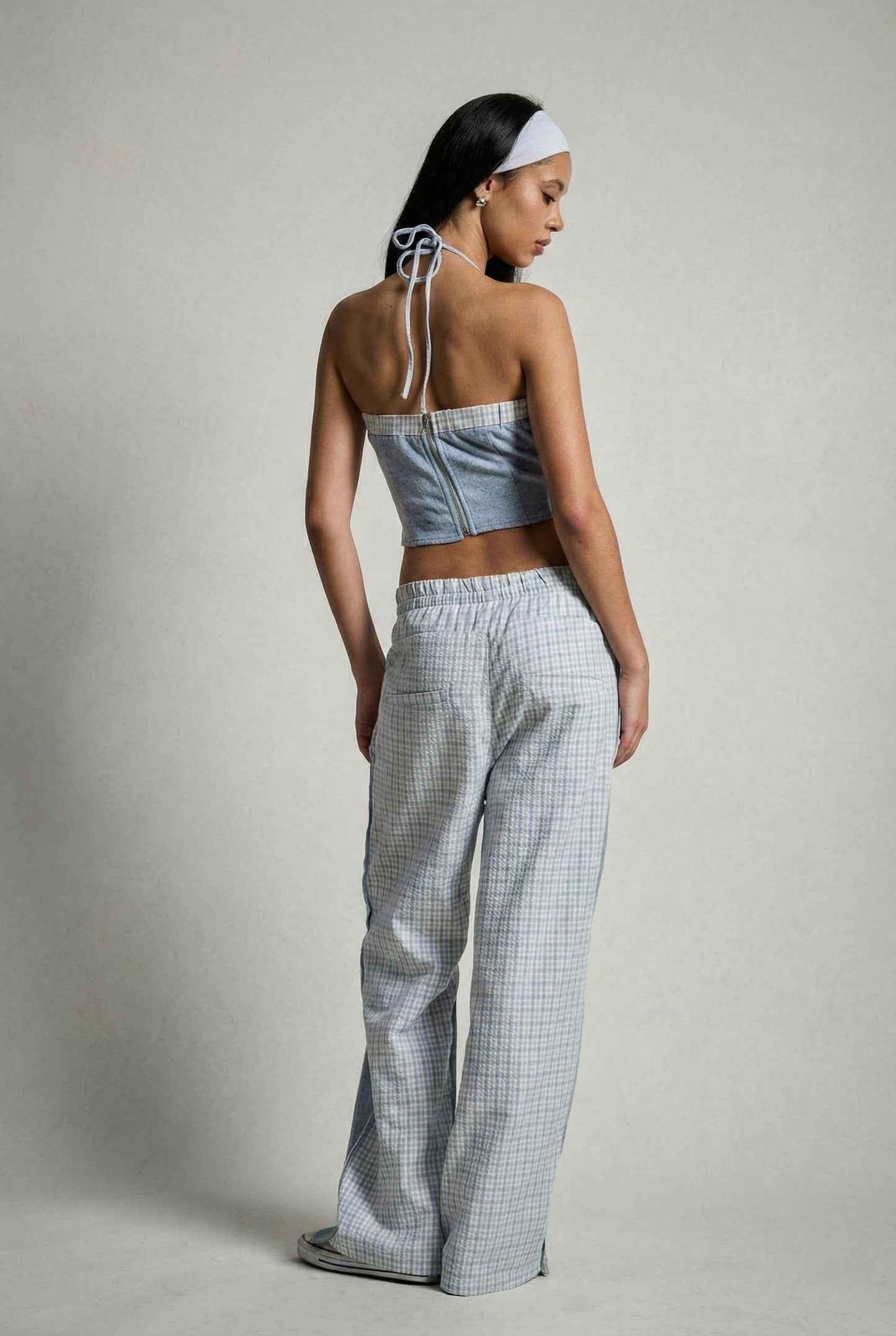 Model wearing Jamie Pants in Blue Double-Waist Boxer Style Trousers with matching halter top and sneakers against plain backdrop