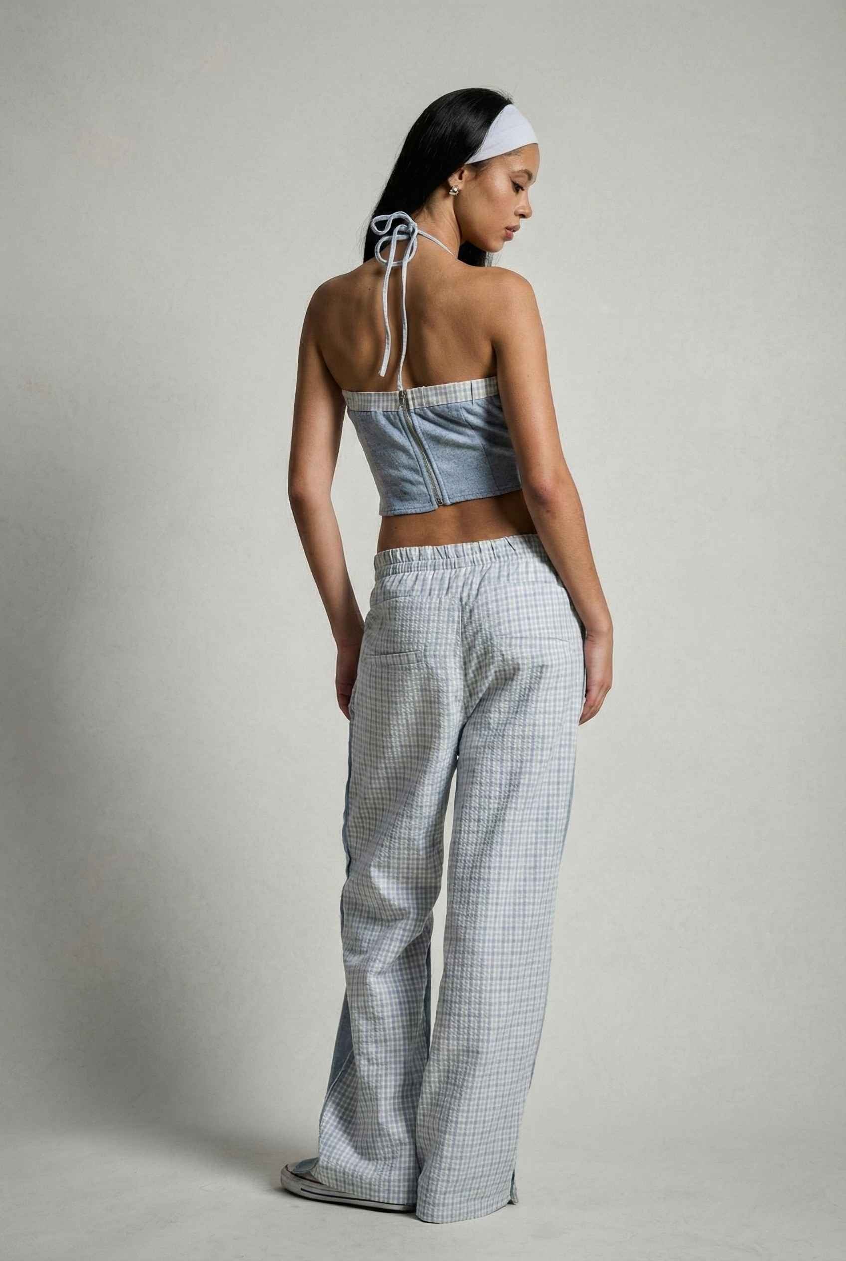 Model wearing Jamie Pants in Blue Double-Waist Boxer Style Trousers with matching halter top and sneakers against plain backdrop