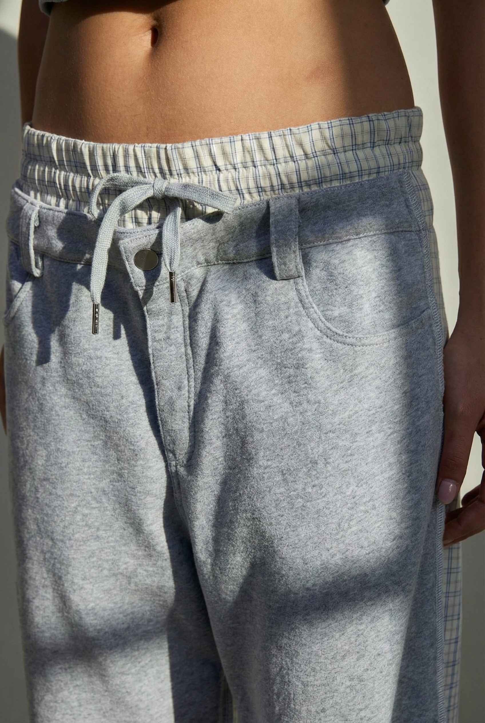 Model wearing Jamie Pants in Blue Double-Waist Boxer Style Trousers with matching halter top and sneakers against plain backdrop