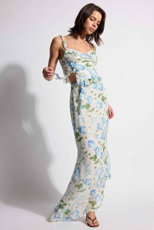 Model wearing  Julia Asymmetrical Floral Bustier Top Ruffle Trim Top in Blue paired with matching maxi skirt and simple heeled sandals