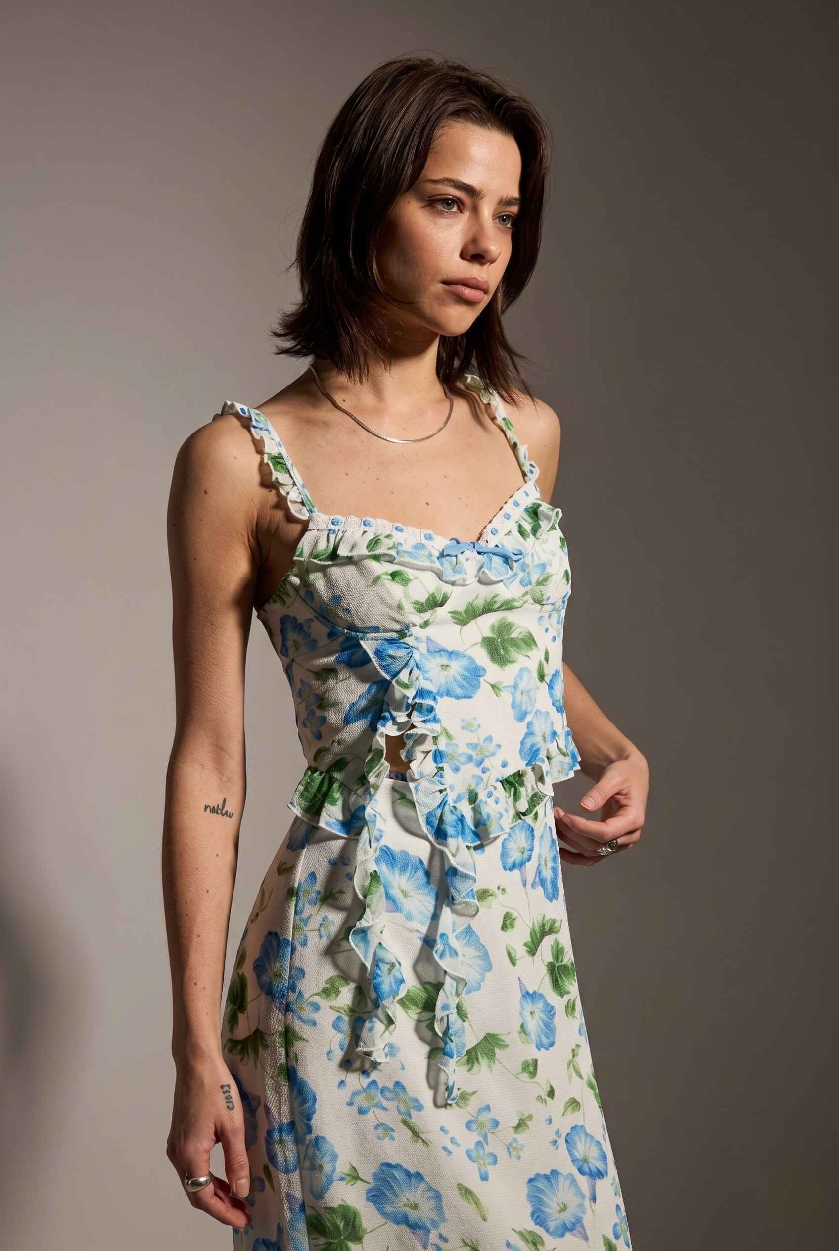 Model wearing  Julia Asymmetrical Floral Bustier Top Ruffle Trim Top in Blue paired with matching maxi skirt