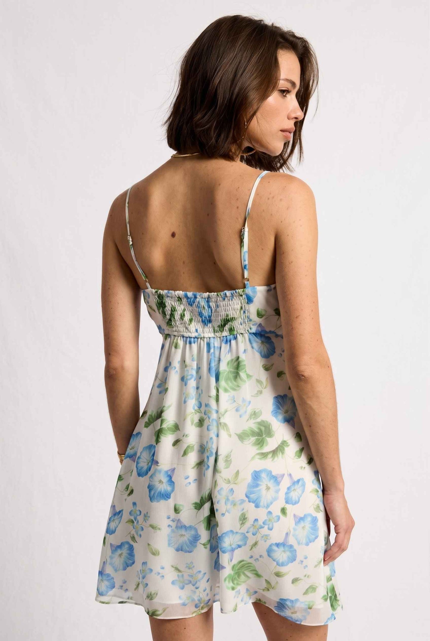 Model wearing Julia V-Neck Ruffle Floral Mini Dress Chiffon Slip Dress in Blue back view