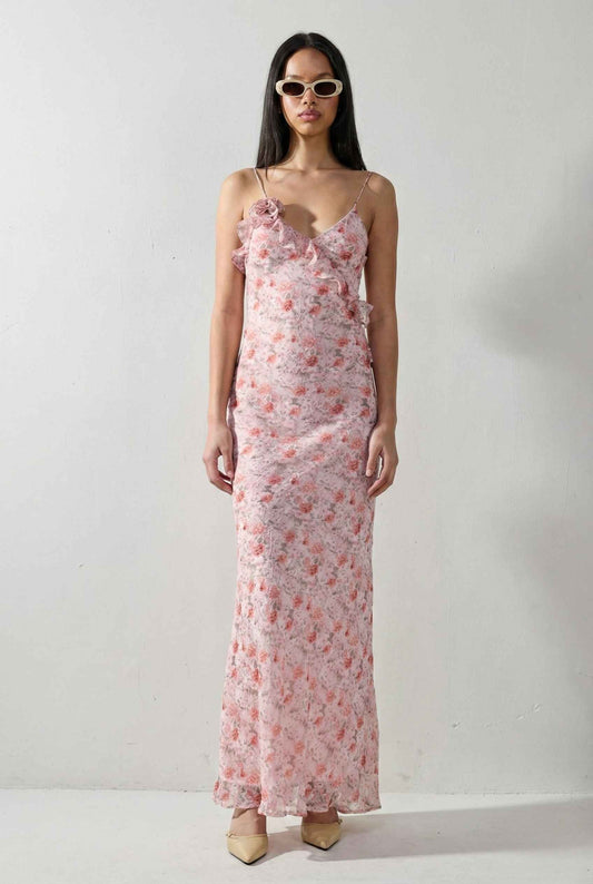 Woman wearing a Julianna Maxi Pink Floral Ruffle Slip Dress against a white background