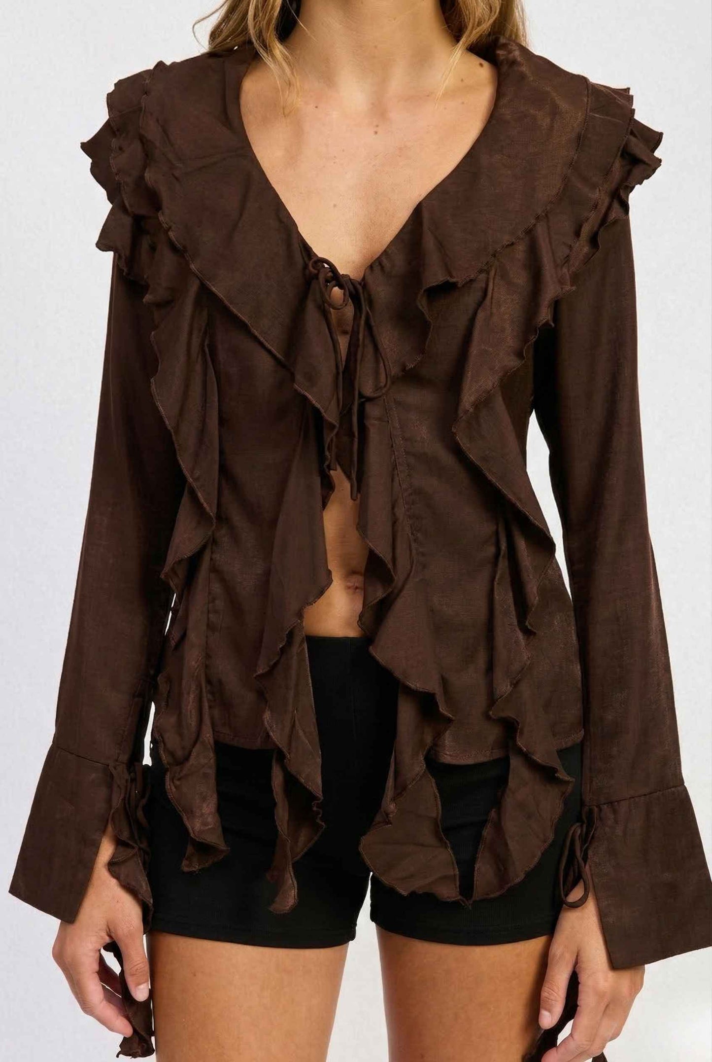 Kaia Top Chocolate Brown Ruffle Tie-Front Long Sleeve Blouse worn by a person on a white background