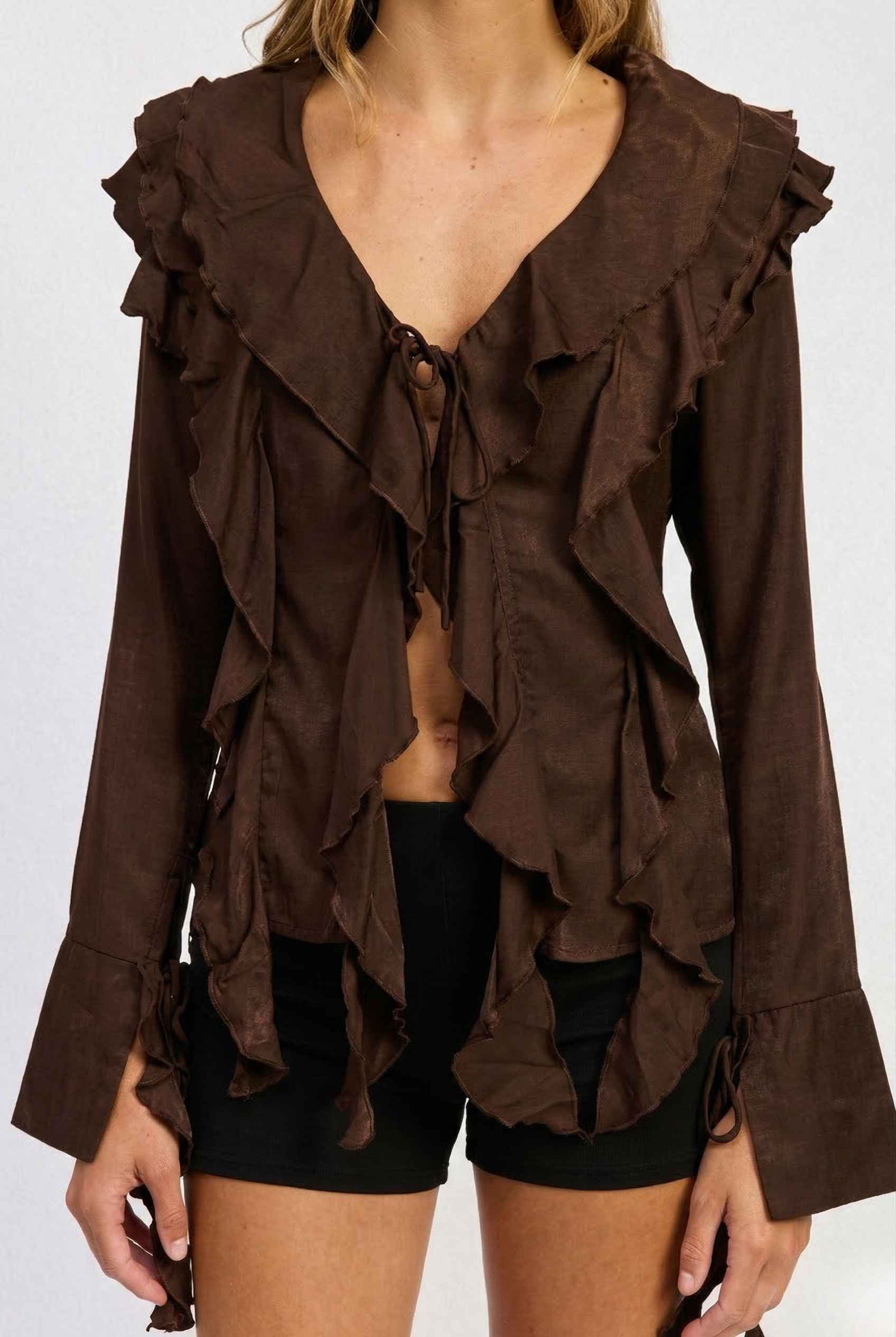 Kaia Top Chocolate Brown Ruffle Tie-Front Long Sleeve Blouse worn by a person on a white background