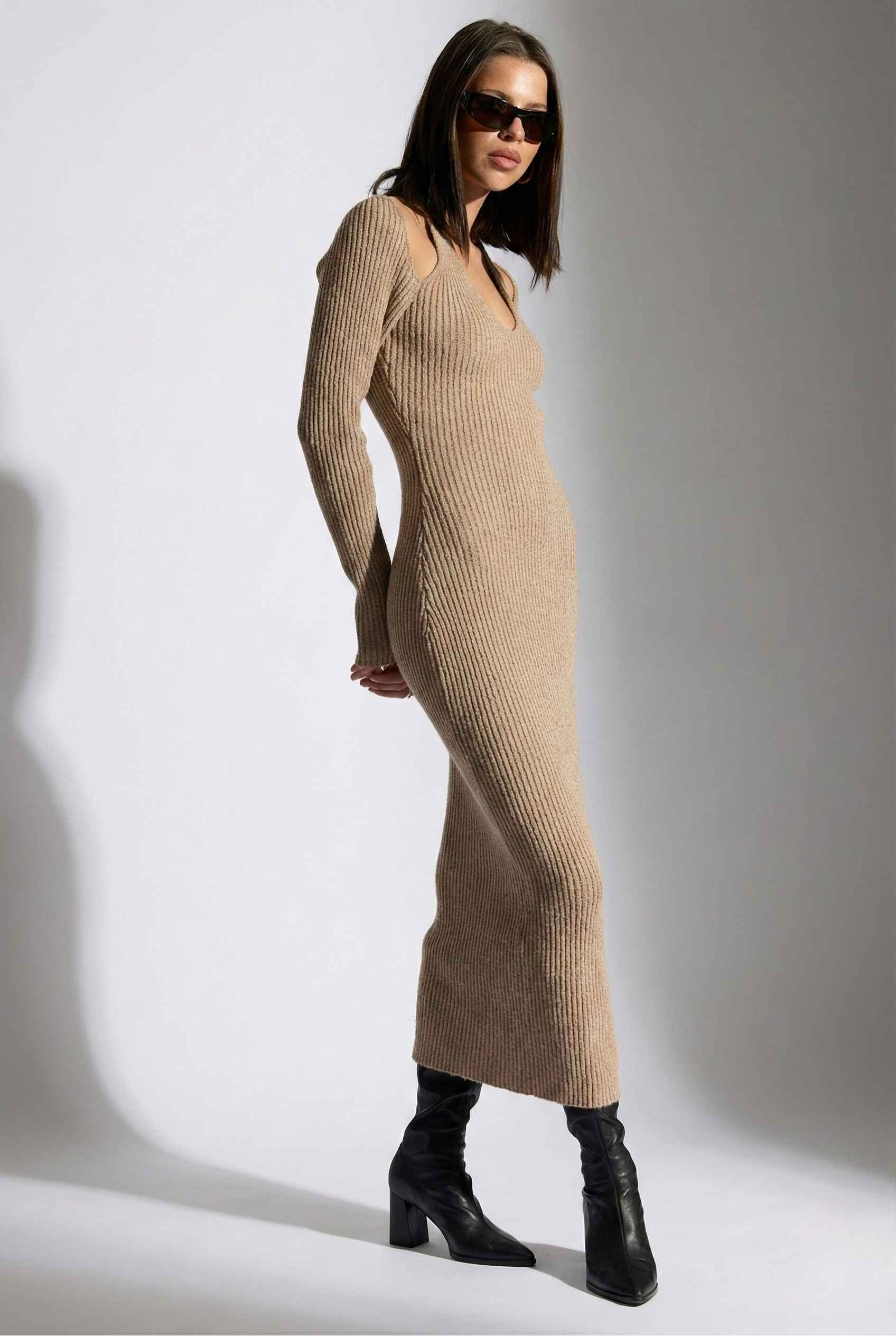 Woman wearing a Keaton Midi Mocha Cutout Shoulder Ribbed Knit Dress with black boots against a white background