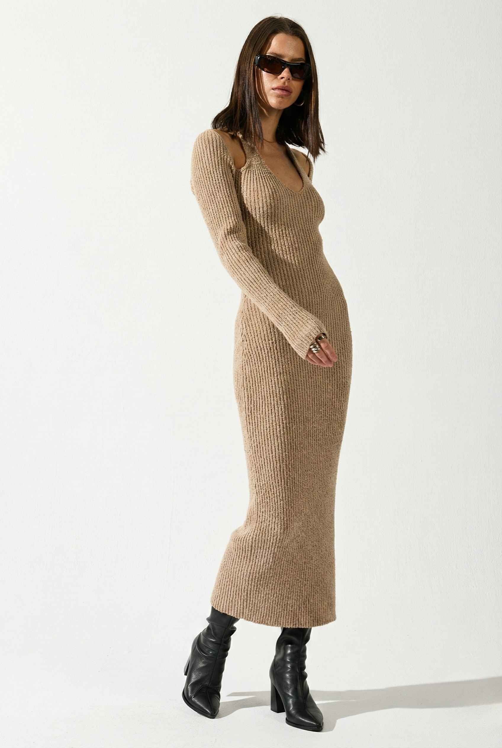 Woman wearing a Keaton Midi Mocha Cutout Shoulder Ribbed Knit Dress and black boots on a white background