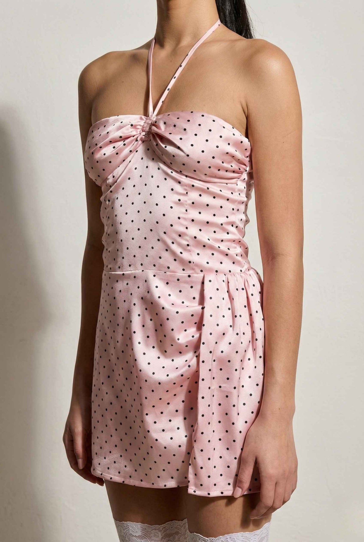 Lola Mini Pink Polka Dot Satin Halter Dress worn by a person on a plain background