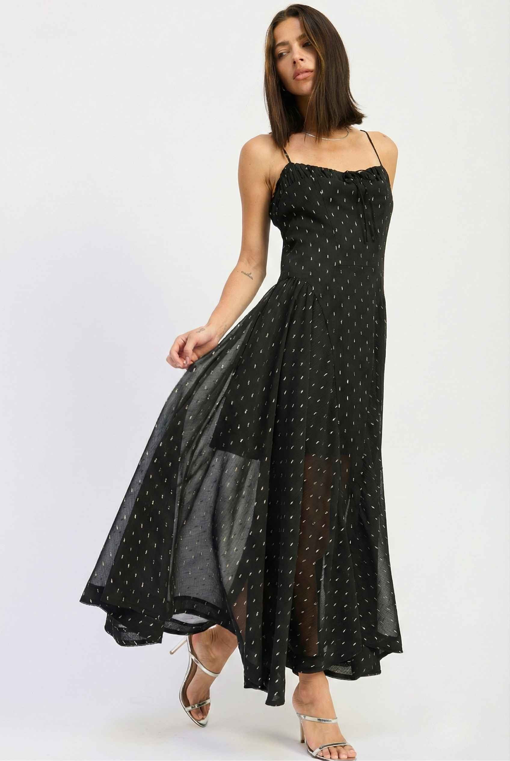 Woman wearing a Lyra Maxi Black Metallic Fleck Chiffon Dress on a white background