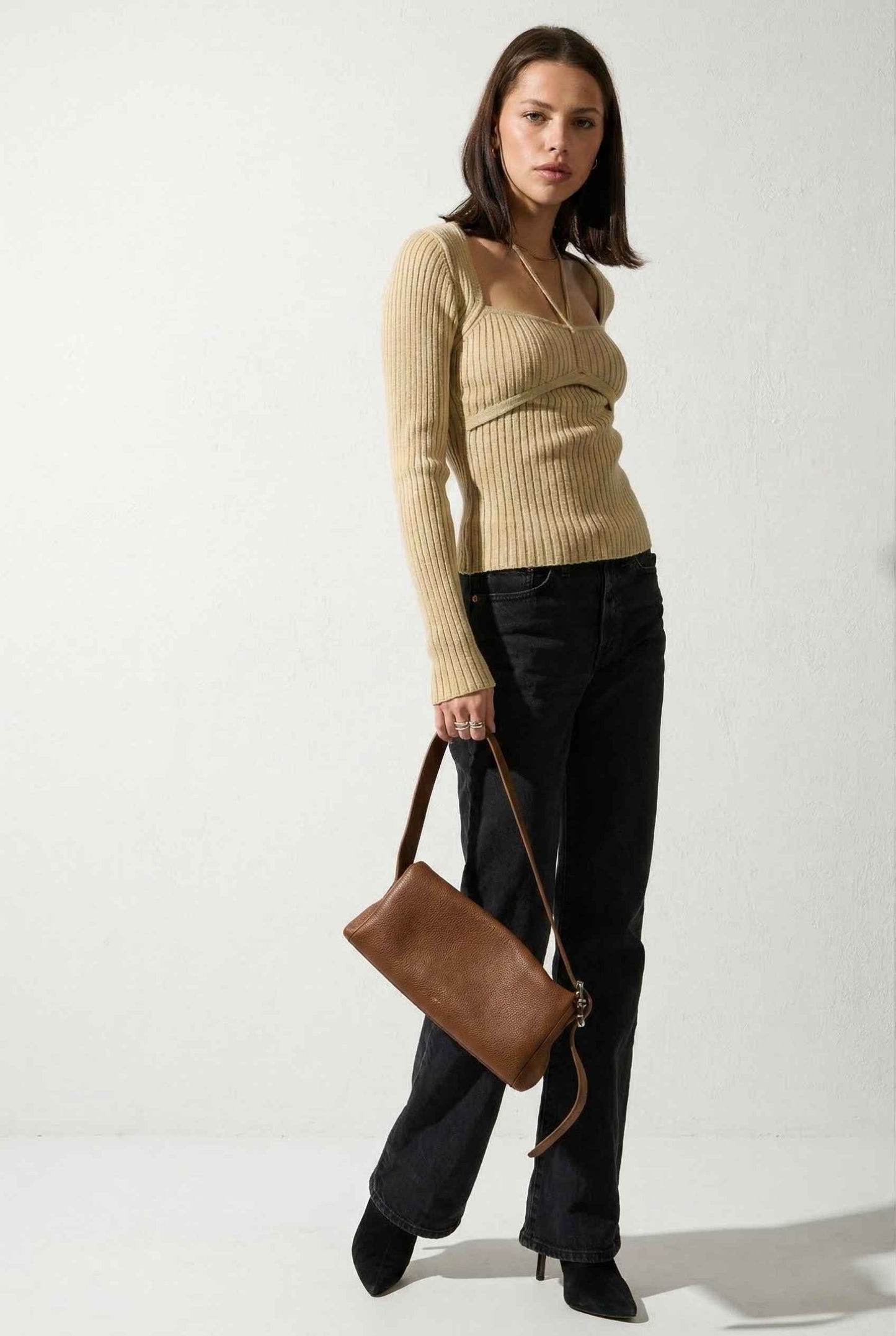 Lyra Top in Cream Beige Square Neck Ribbed Knit Top with Halter Strap Detail paired with trousers and heels