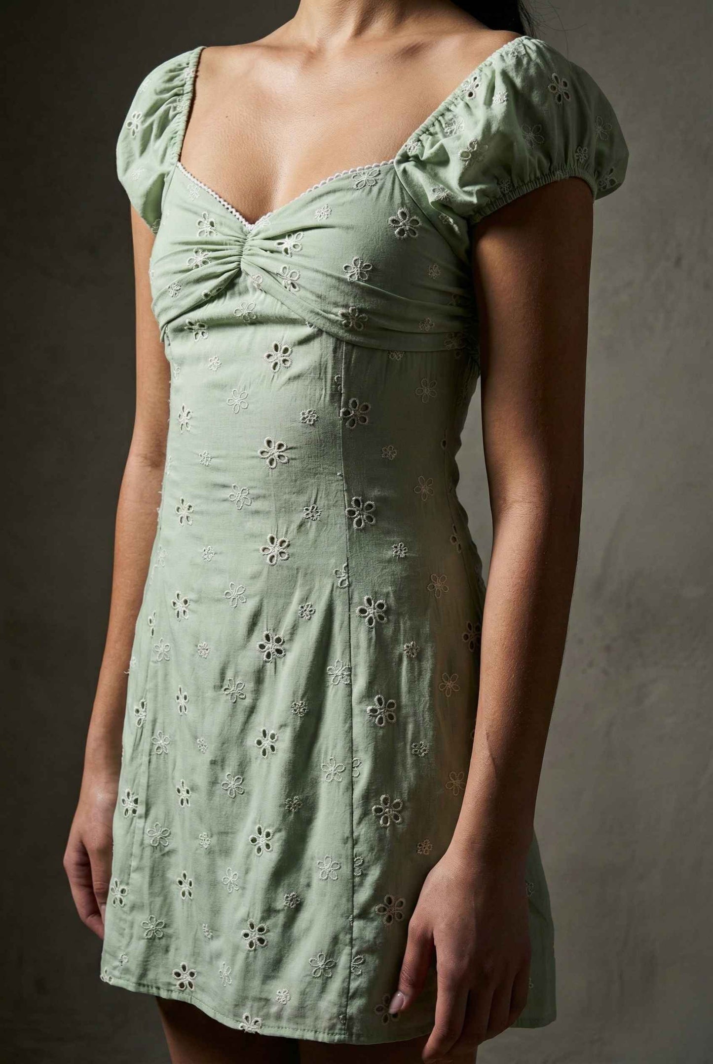 Maeve Mini Mint Eyelet Ruched Puff Sleeve Dress with floral patterns on a plain background