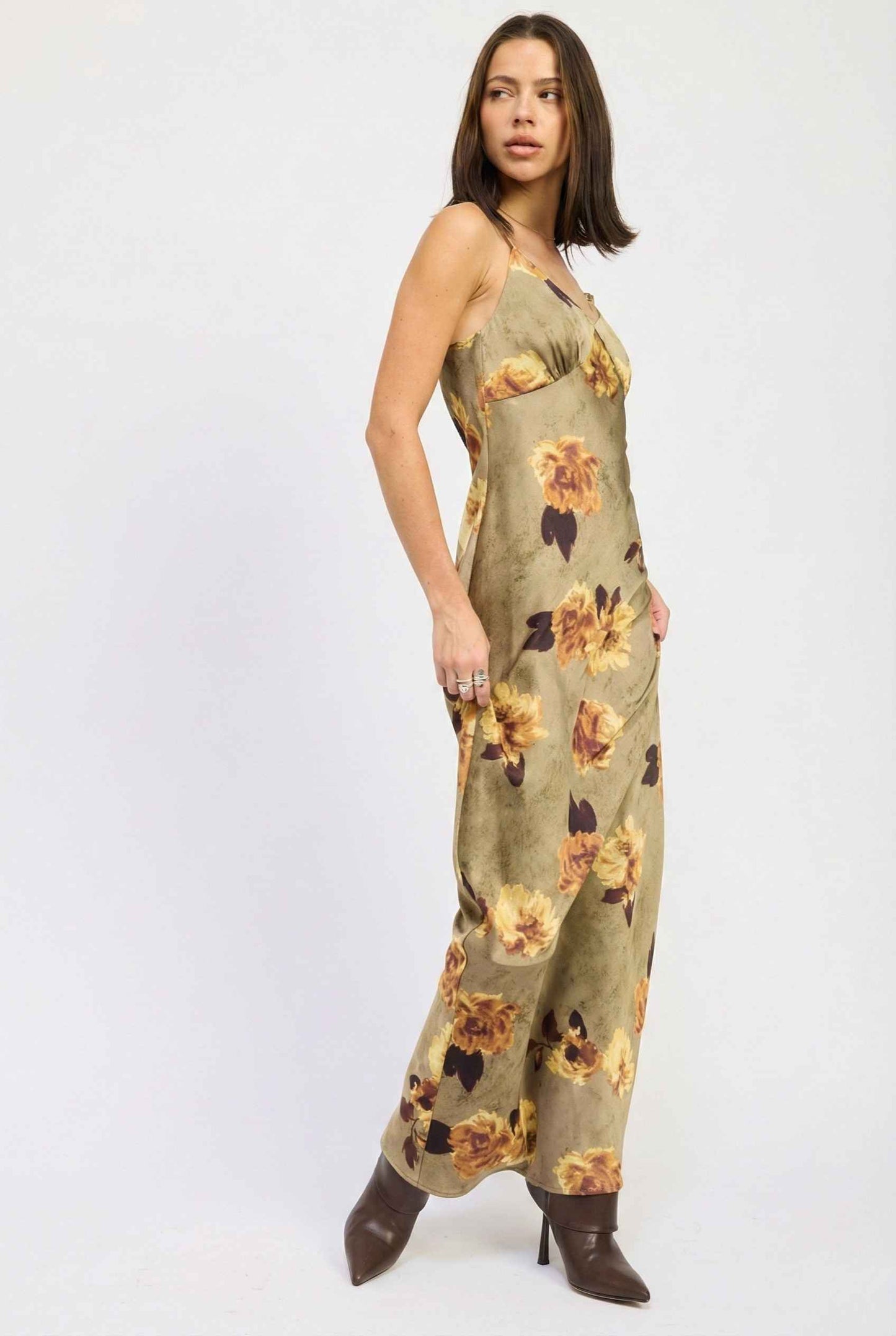 Woman wearing a Marcella Maxi Olive Floral Satin Slip Dress on a white background
