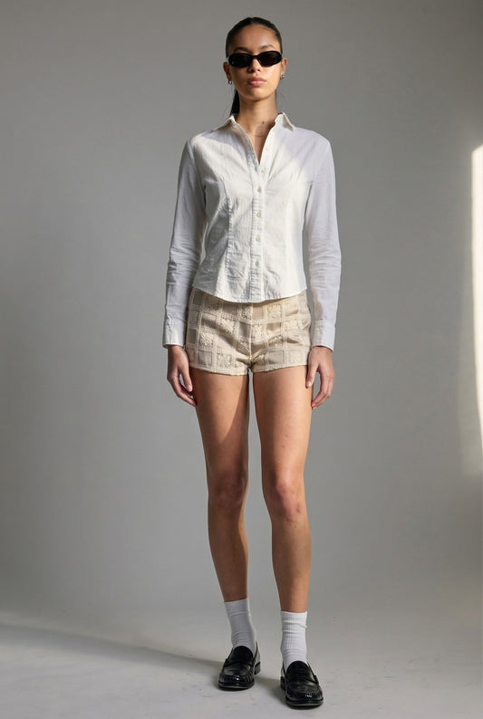 Model wearing Maren Shorts in Natural Jacquard Crochet Check Micro Shorts paired with crisp poplin blouse and shiny loafers with socks