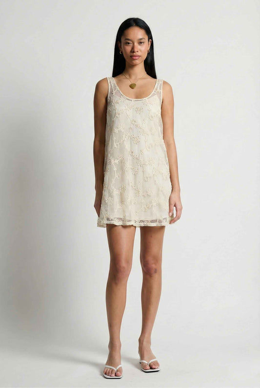 Woman wearing a Marisol Mini Cream Floral Crochet Shift Dress against a plain background