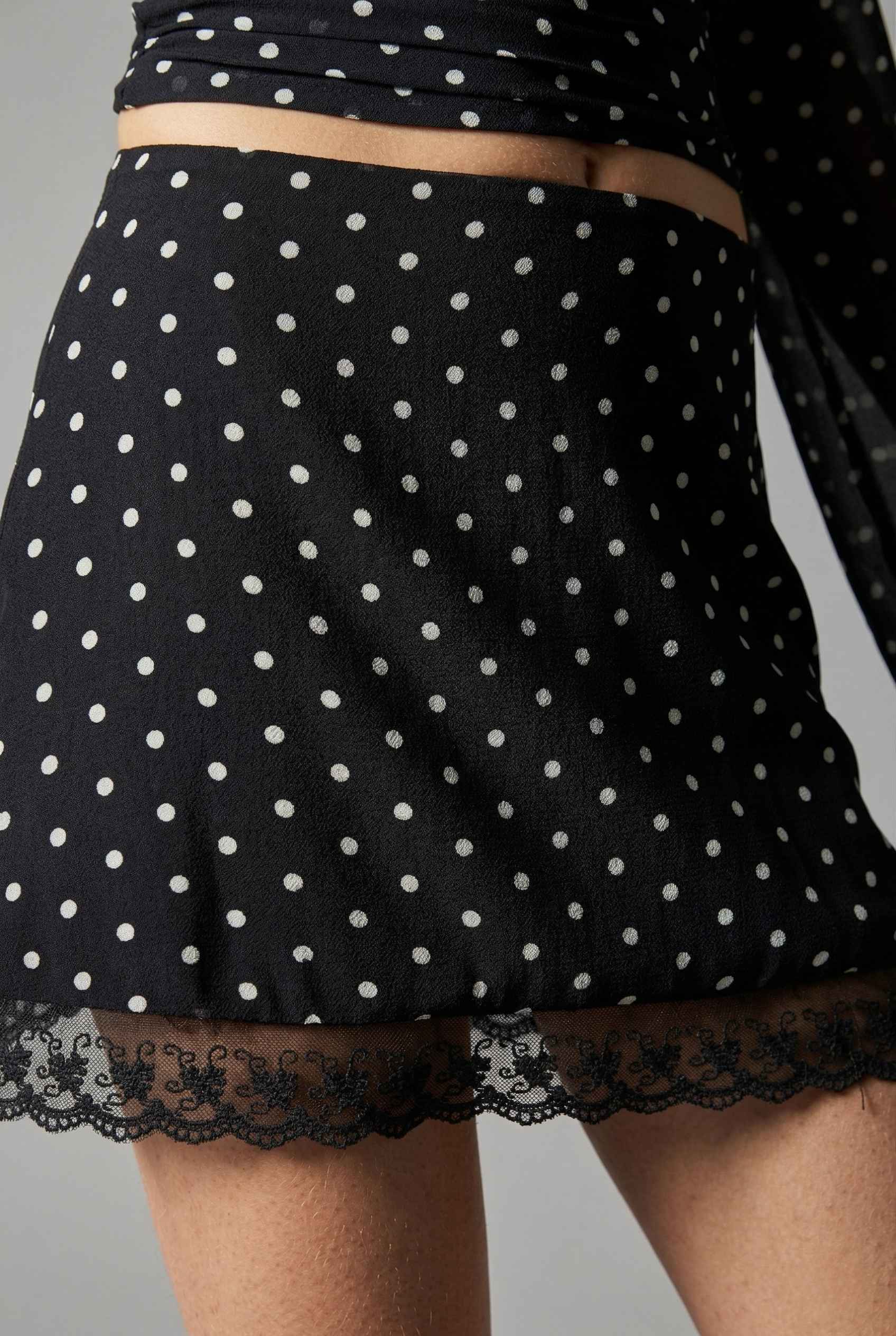 Mila Skirt Black Polka Dot Mesh Mini Skirt with Lace Trim with lace trim on a neutral background