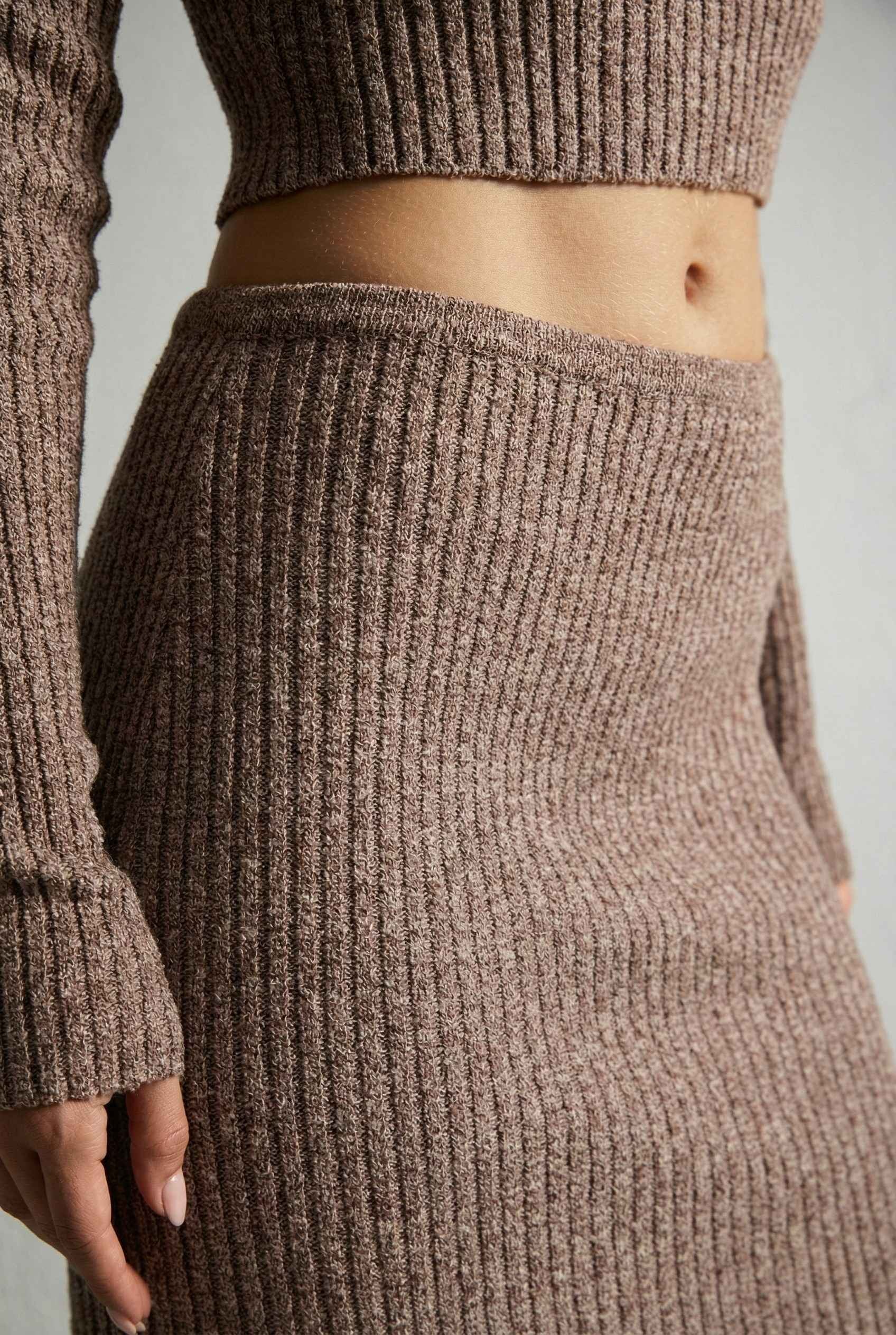 Model wearing Mila Skirt Marled Ribbed Knit Column Maxi Skirt in Brown with matching sweater top on a plain background
