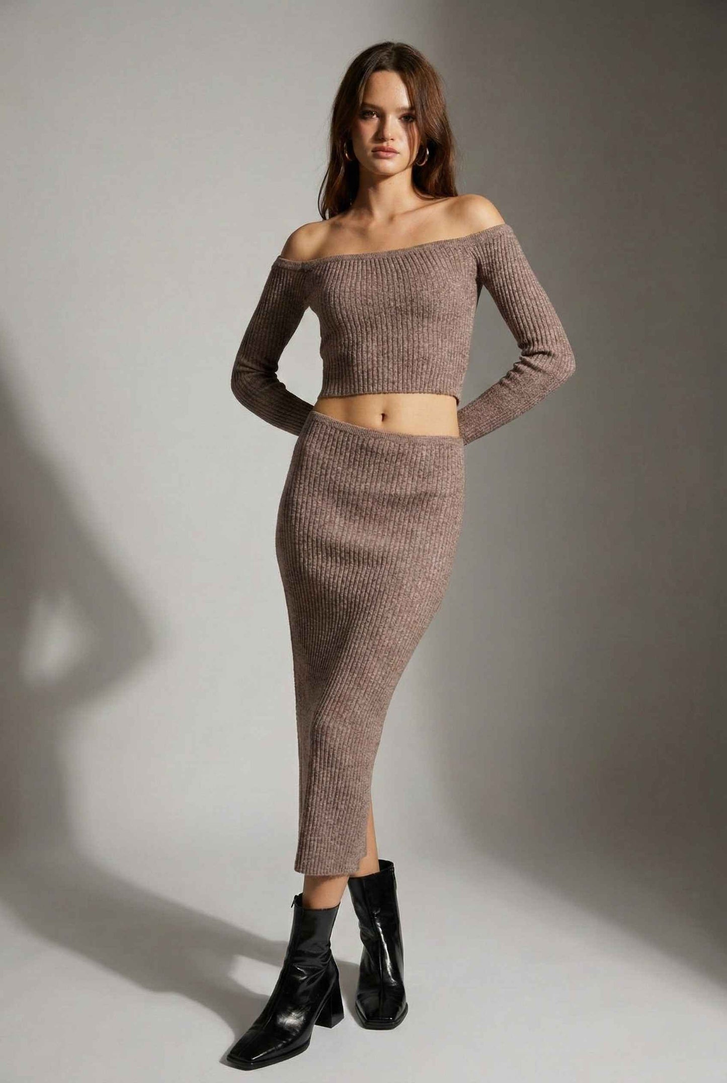 Model wearing Mila Skirt Marled Ribbed Knit Column Maxi Skirt in Brown with matching sweater top and heeled boots on a plain background
