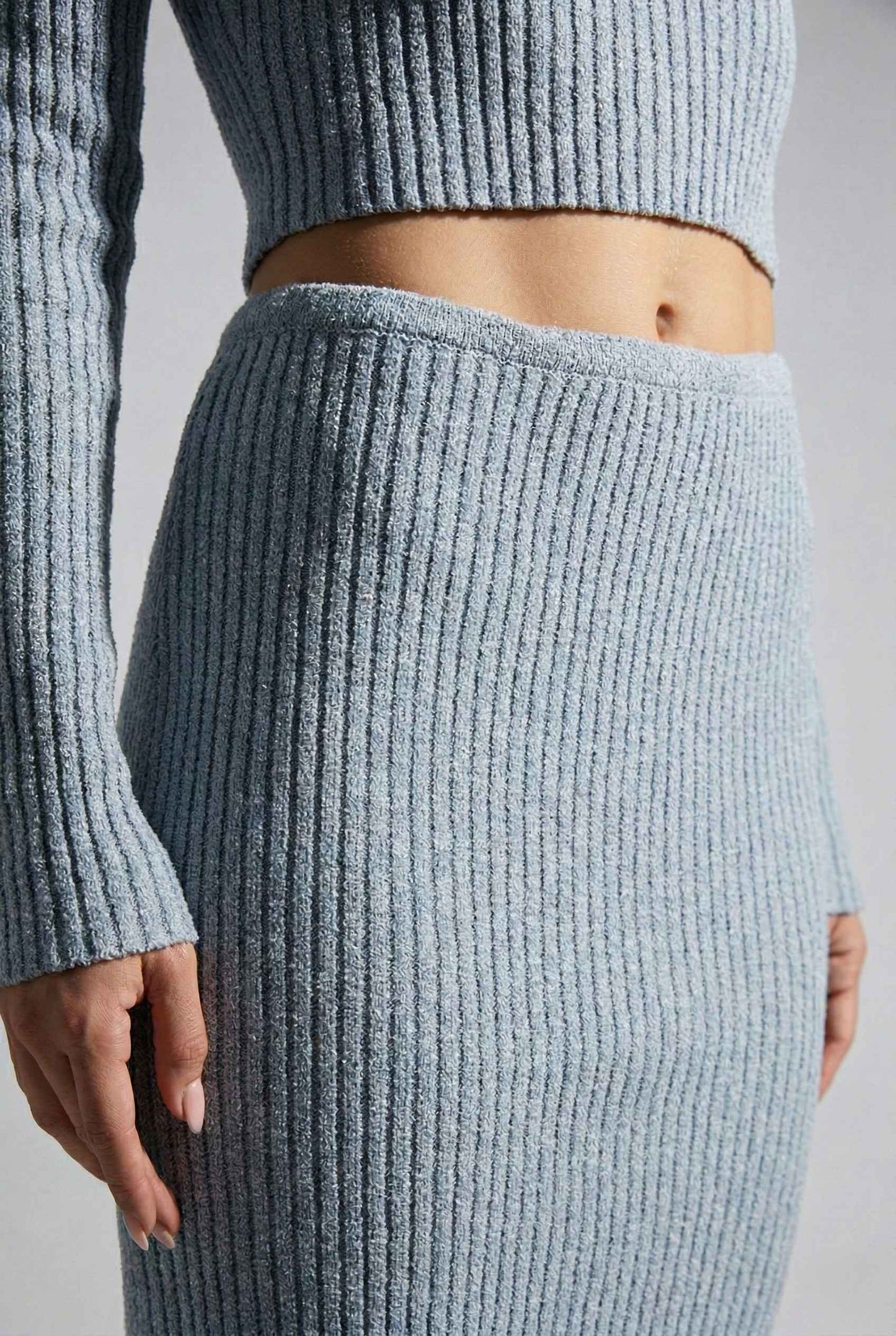 Model wearing Mila Skirt Marled Ribbed Knit Column Maxi Skirt in Light Blue with matching sweater top on a plain background