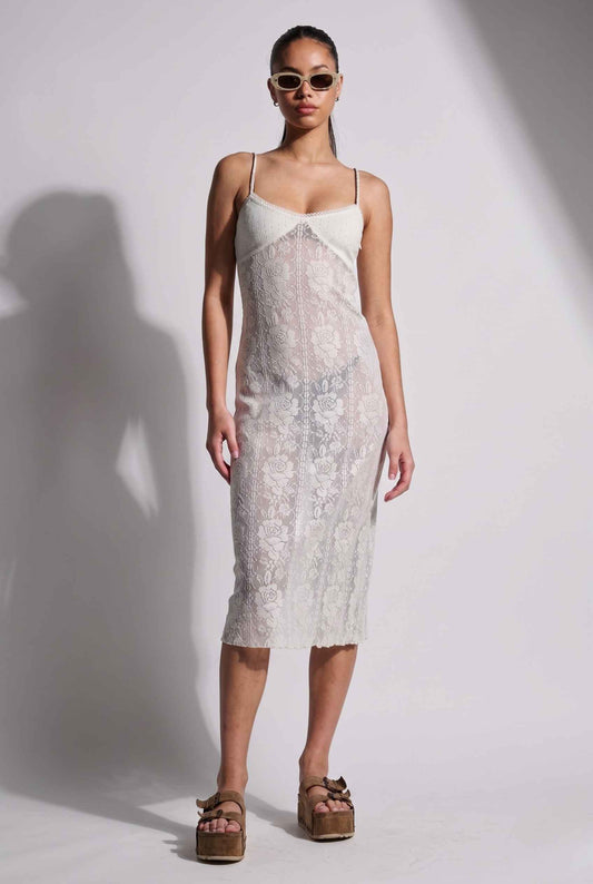 Woman wearing a Ophelia Midi White Floral Lace Slip Dress against a plain background