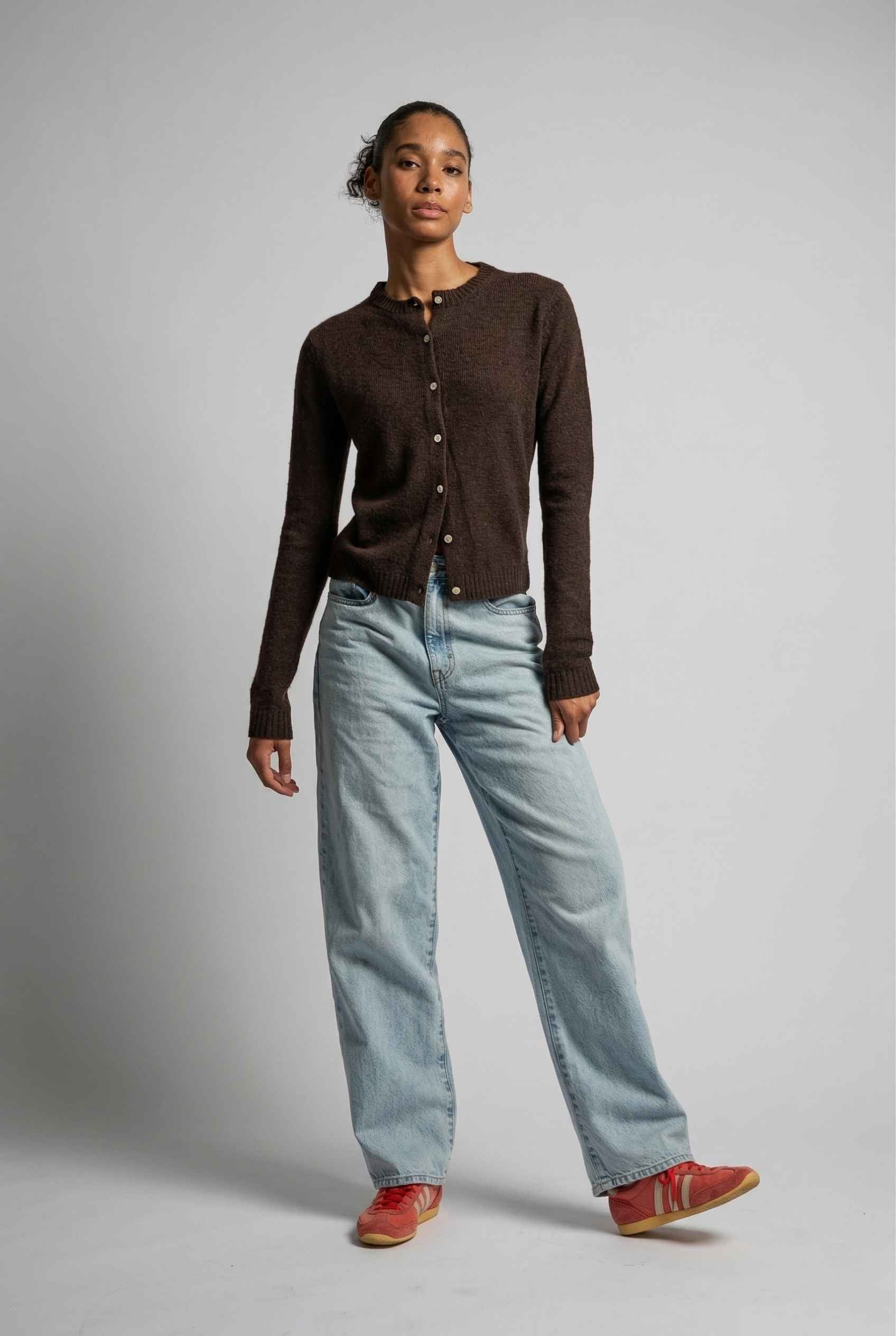 Model wearing Penelope Top in Chocolate Soft Wool-Blend Crew Neck Button-Up Cardigan with jeans and sneakers