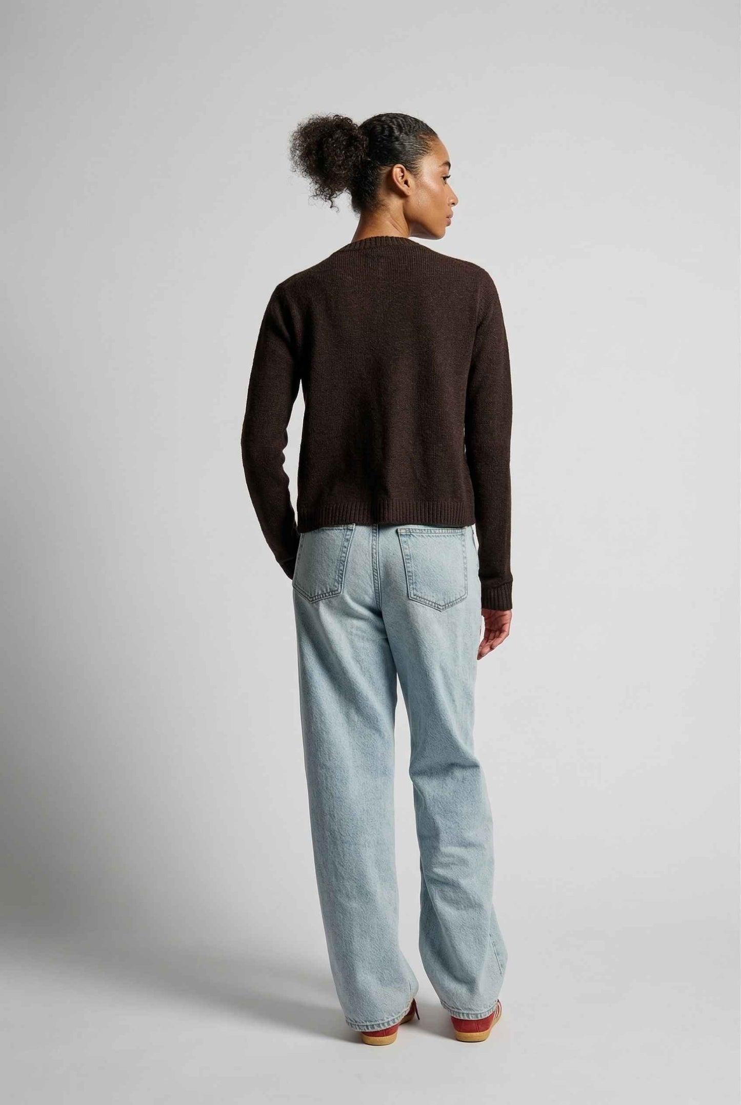 Model wearing Penelope Top in Chocolate Soft Wool-Blend Crew Neck Button-Up Cardigan with jeans and sneakers