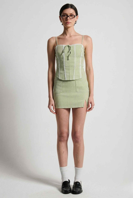 Woman wearing a Piper Top Green Gingham Lace Trim Corset Cami on a white background