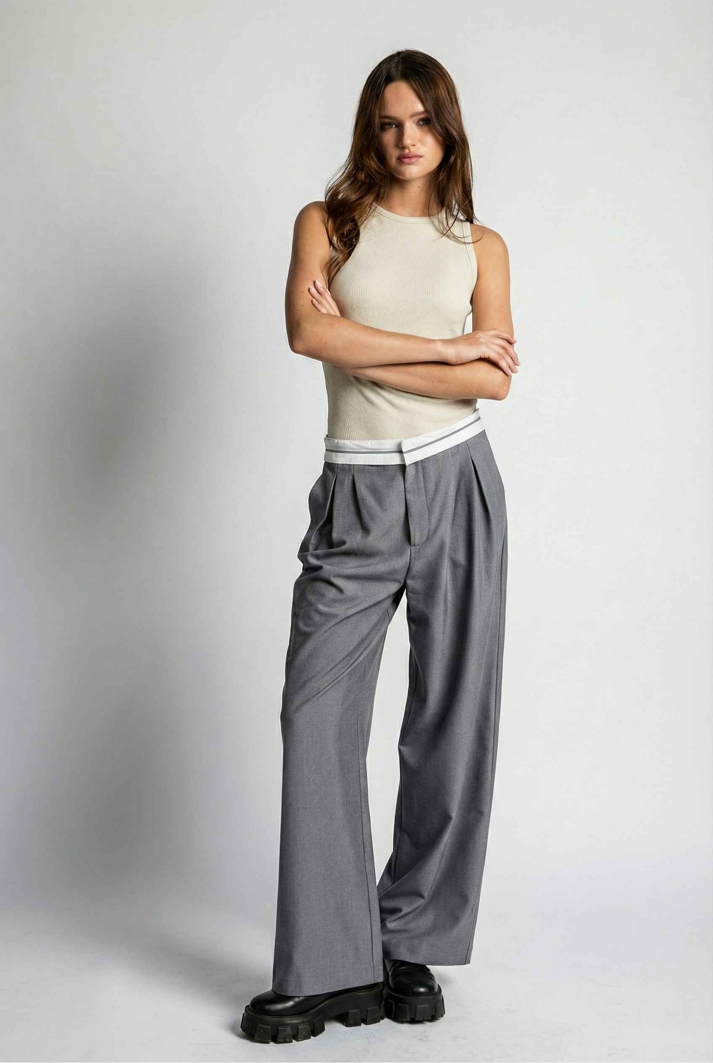 Model wearing Remi Pants in Grey Tailored Trousers with Contrast Fold-Over Waistband paired with basic tank and loafers