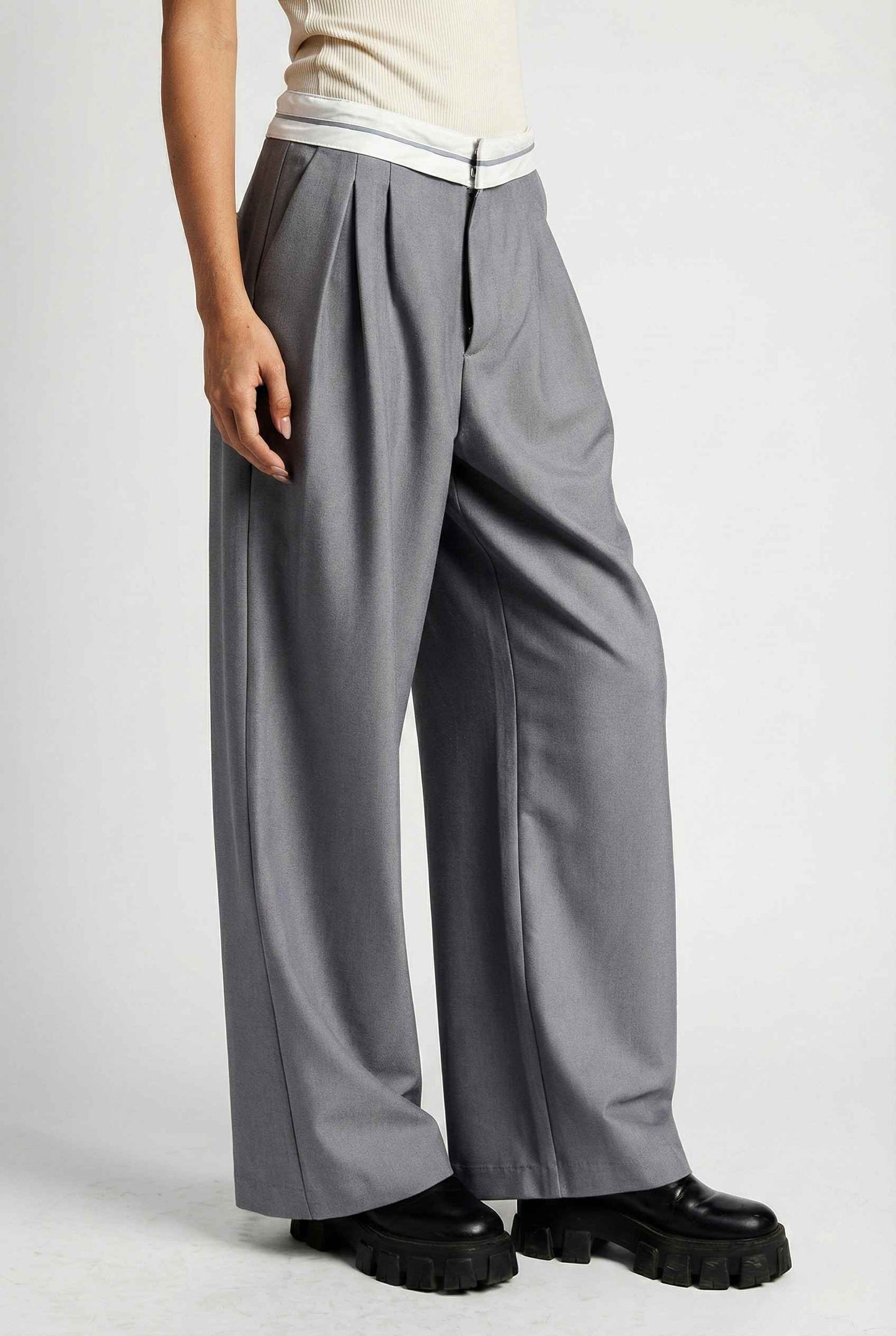 Model wearing Remi Pants in Grey Tailored Trousers with Contrast Fold-Over Waistband paired with basic tank and loafers
