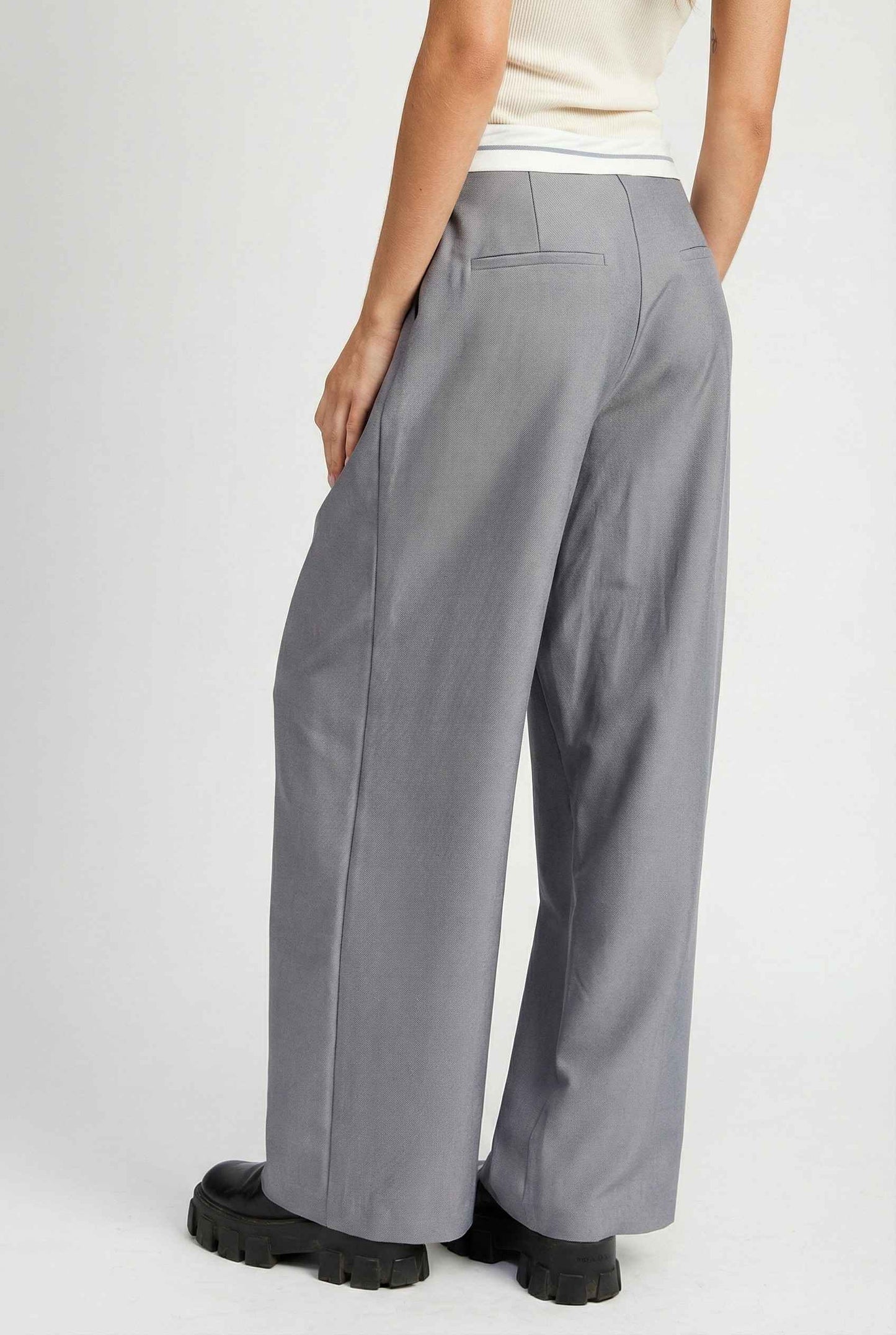 Model wearing Remi Pants in Grey Tailored Trousers with Contrast Fold-Over Waistband paired with basic tank and loafers