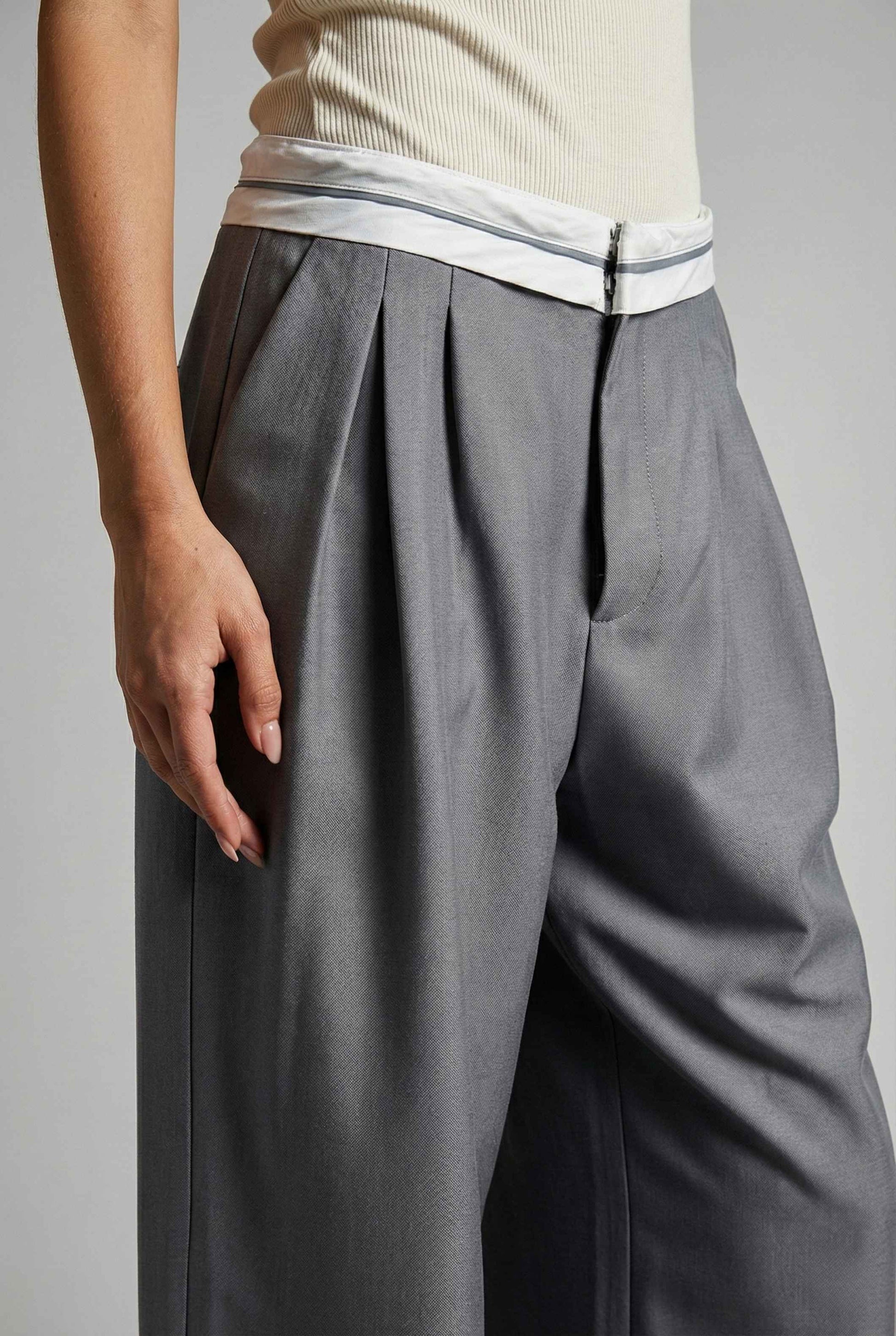 Model wearing Remi Pants in Grey Tailored Trousers with Contrast Fold-Over Waistband paired with basic tank