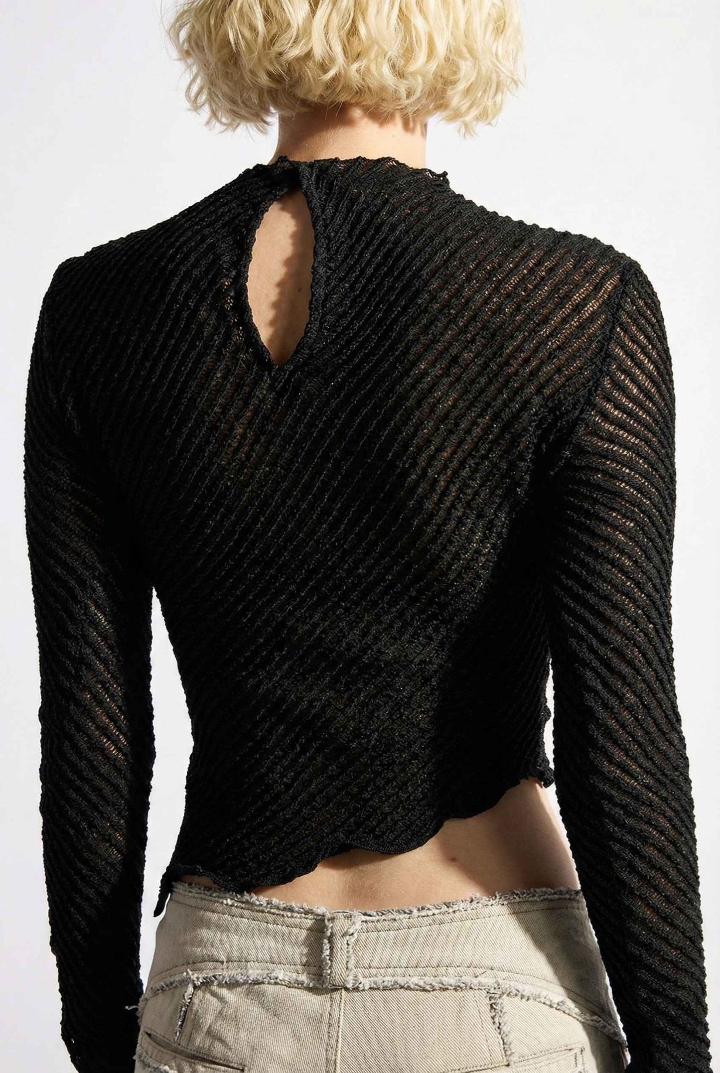Ren Top Black Asymmetrical Diagonal Rib Long Sleeve worn by a woman on a plain background