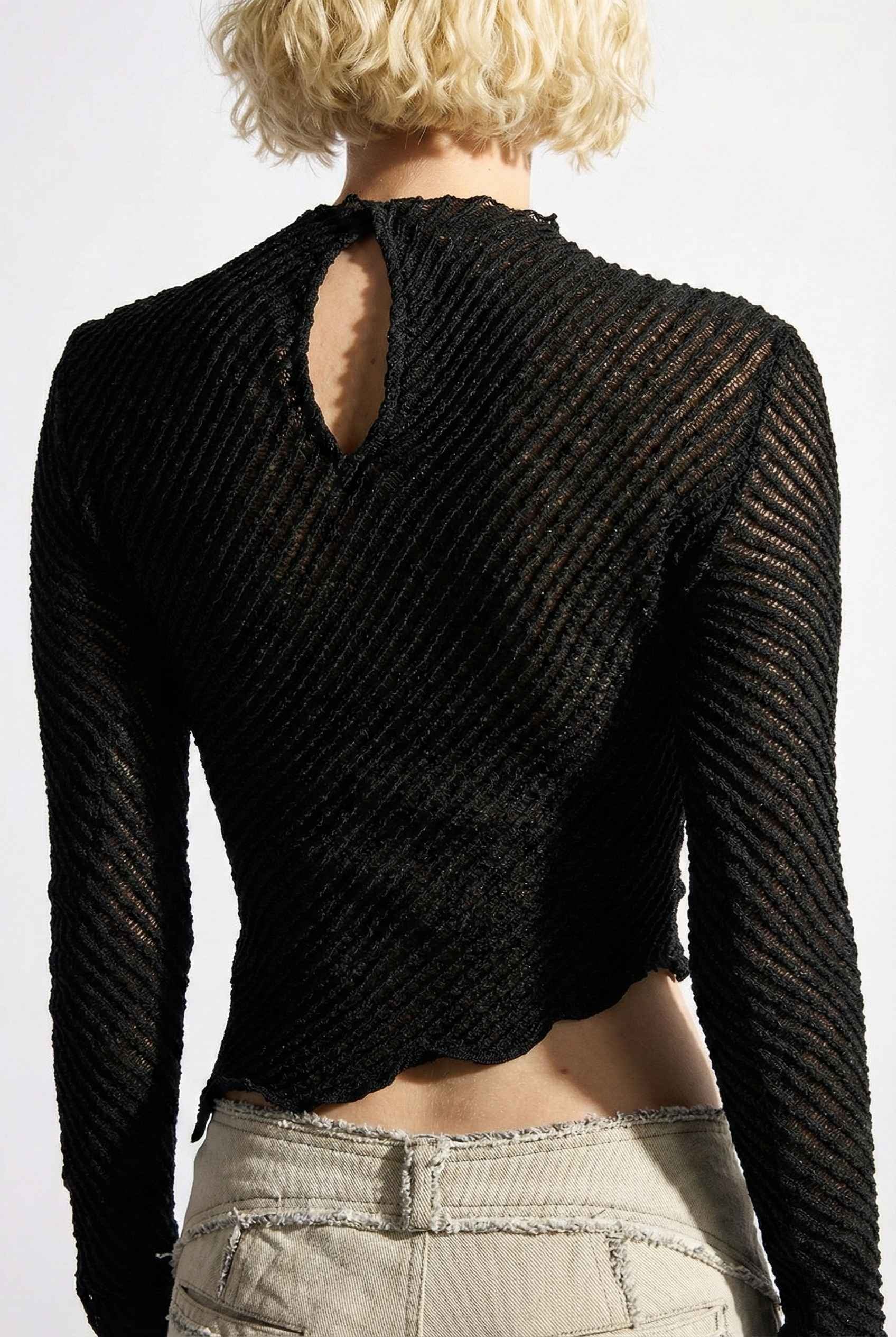 Ren Top Black Asymmetrical Diagonal Rib Long Sleeve worn by a woman on a plain background