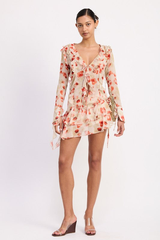 Emory Park Ruffle Trim Sheer Peplum Red Top with floral pattern worn by model with long sleeves and v-neck