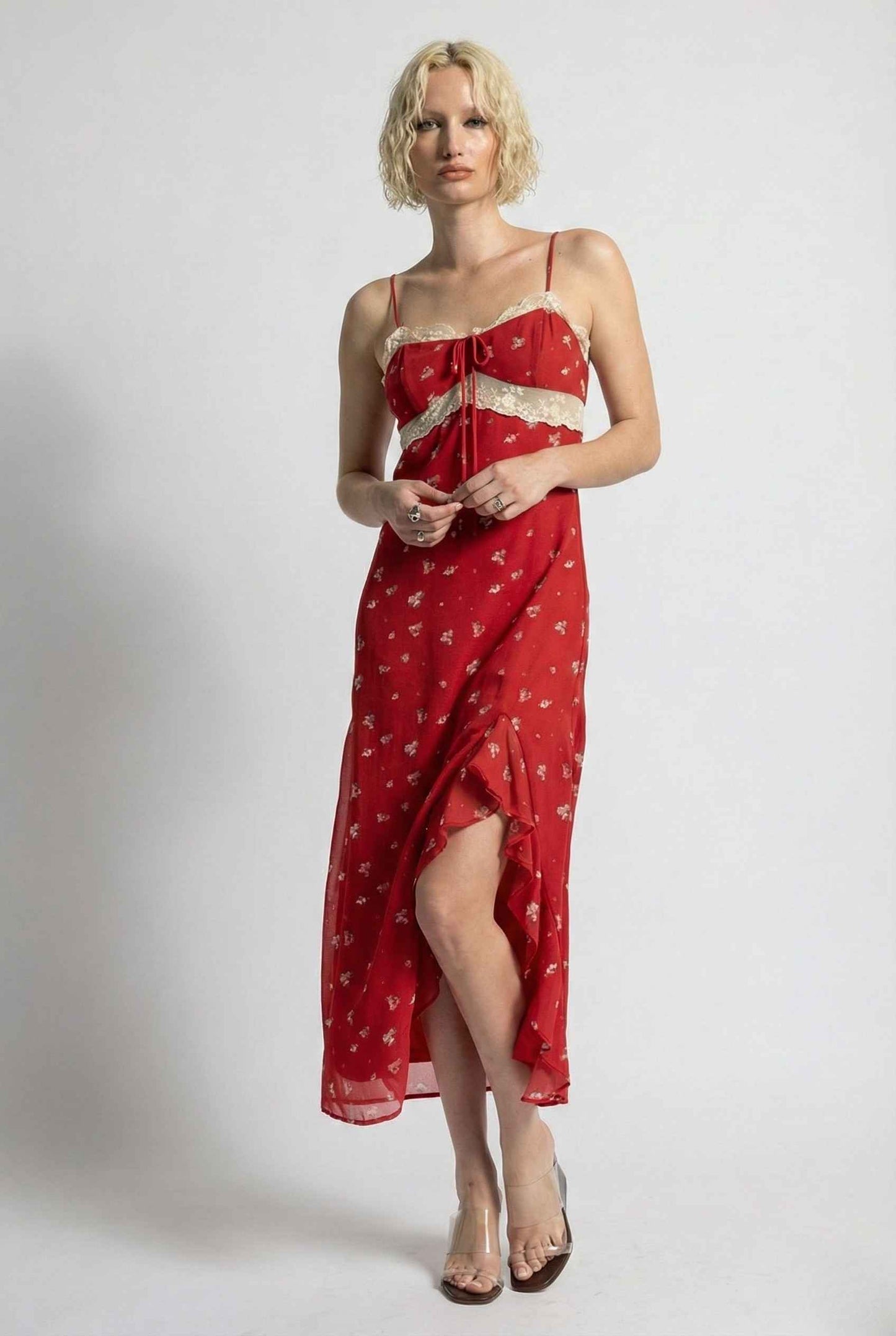 Woman wearing a Scarlett Maxi Red Floral Lace Trim Dress with white patterns on a plain background
