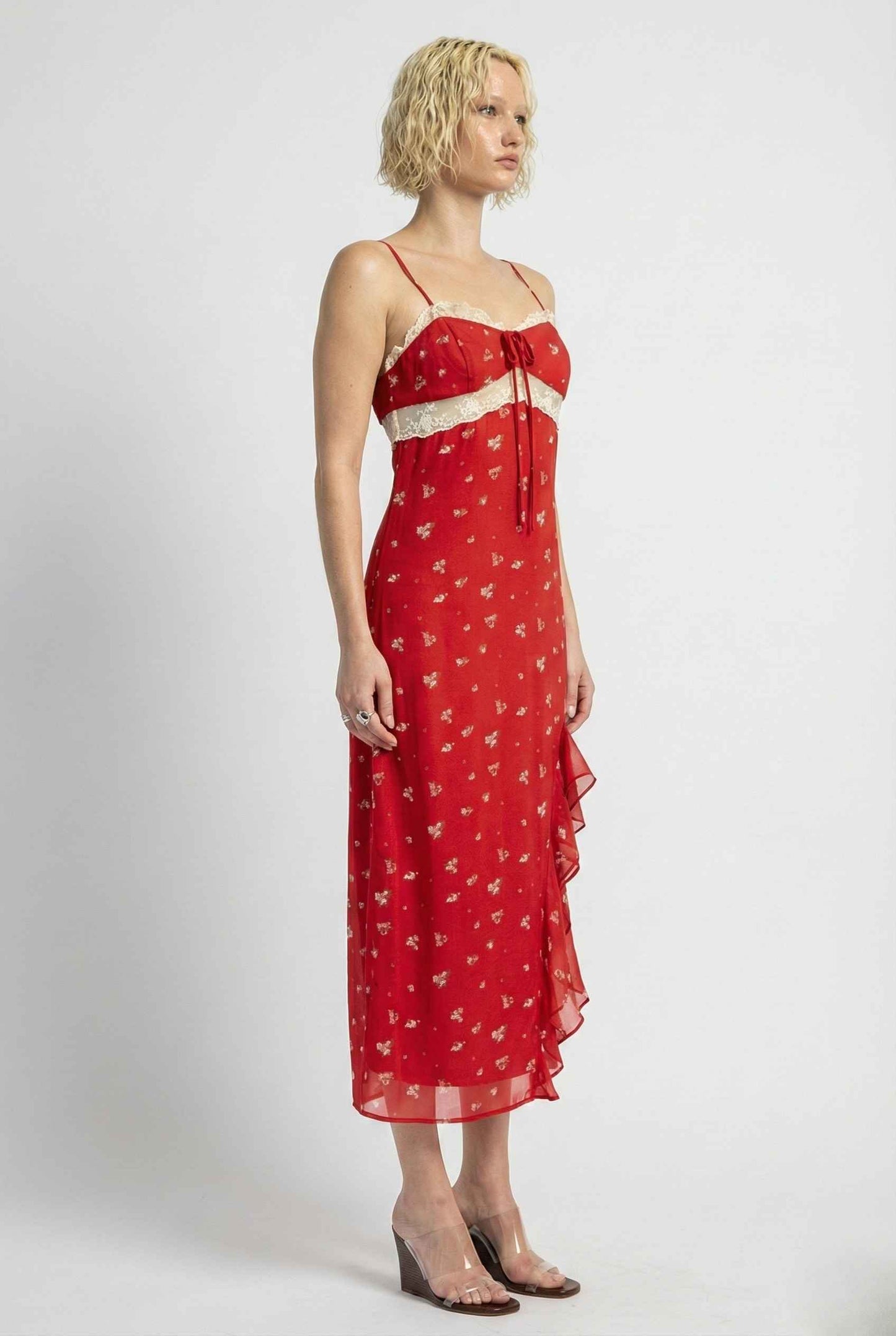 Woman wearing a Scarlett Maxi Red Floral Lace Trim Dress with a white strap on a white background