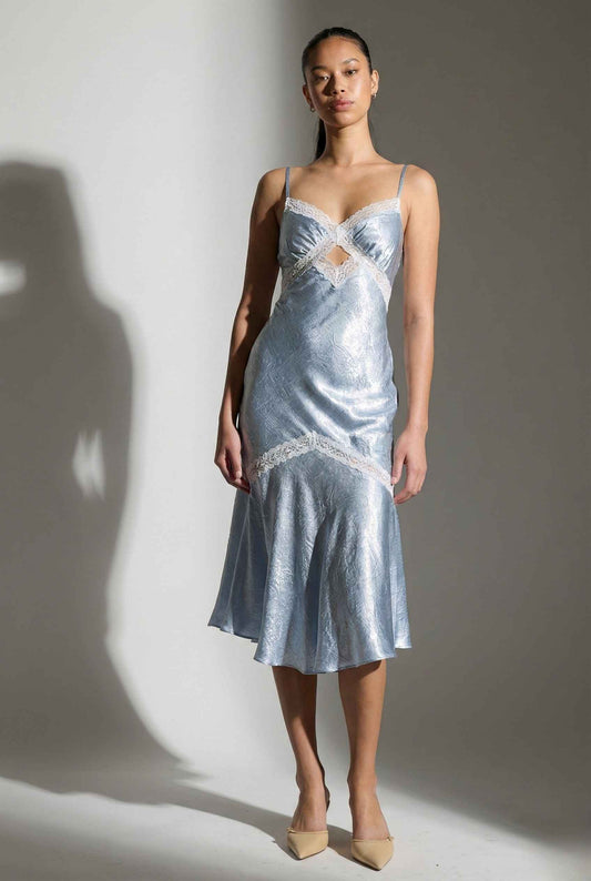Woman wearing a Seraphina Midi Light Blue Satin Lace Cutout Dress with lace details against a gray background