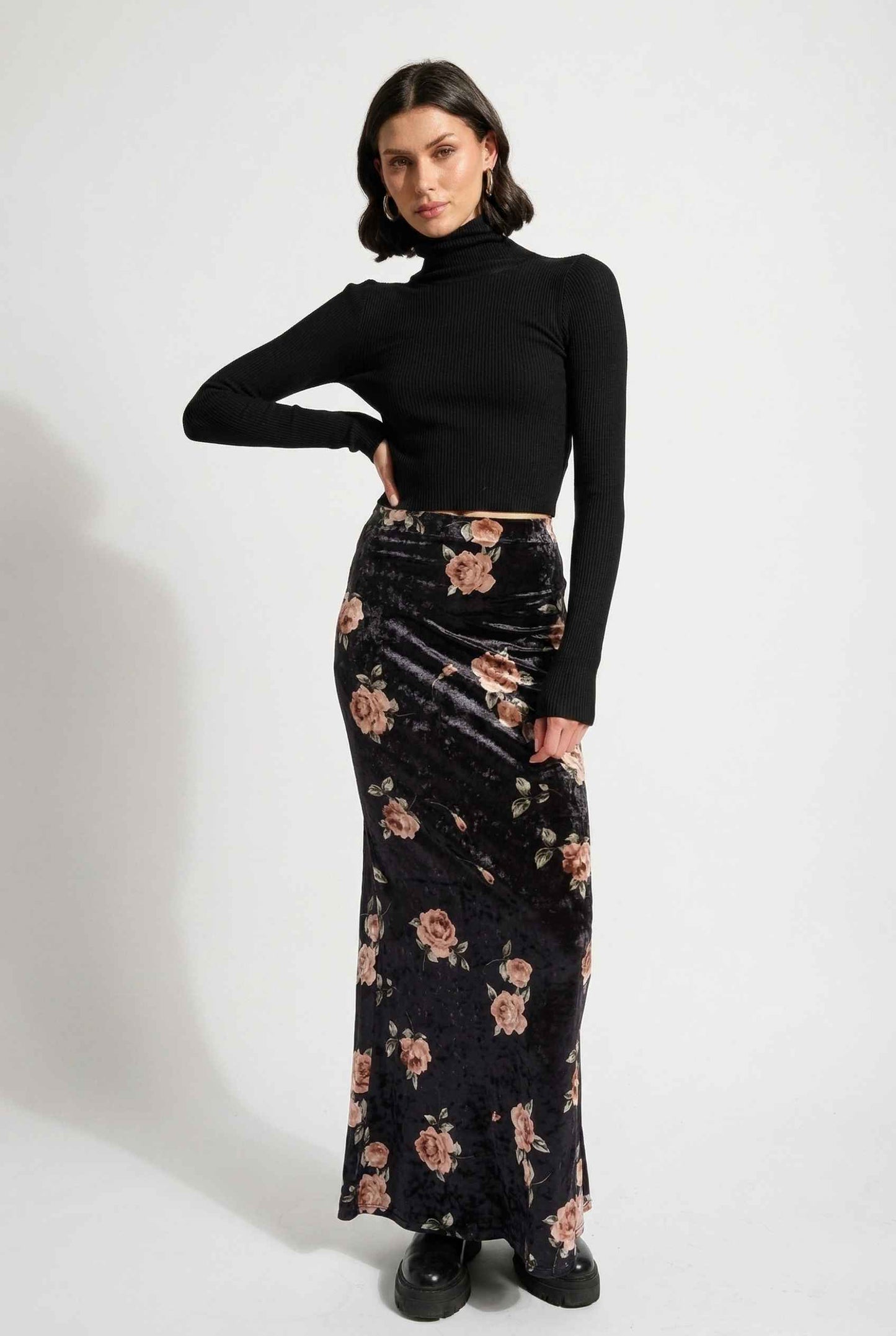 Model wearing Seraphina Skirt in Black Floral Stretch Velvet Column Maxi Skirt with sleek turtleneck and shiny loafers