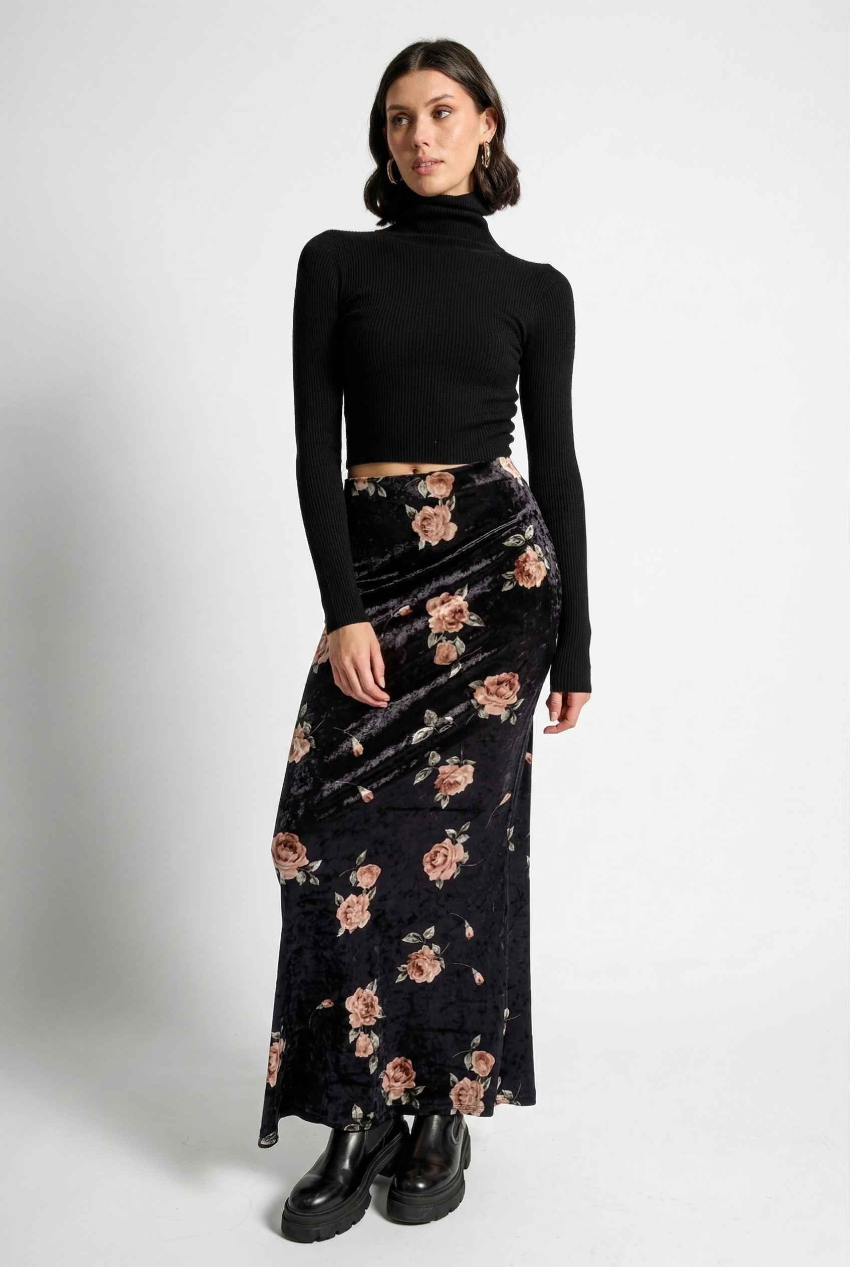 Model wearing Seraphina Skirt in Black Floral Stretch Velvet Column Maxi Skirt with sleek turtleneck and shiny loafers