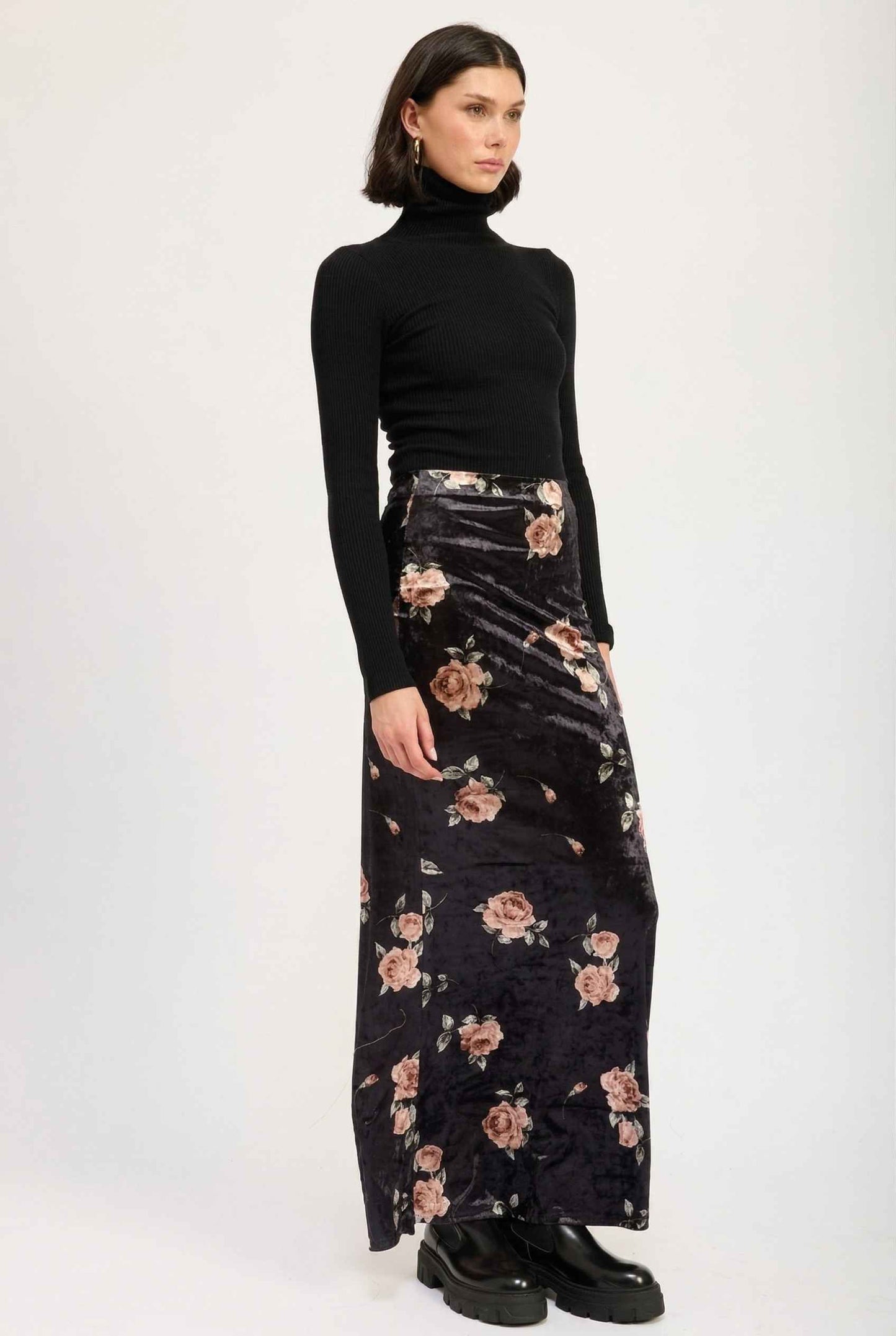 Model wearing Seraphina Skirt in Black Floral Stretch Velvet Column Maxi Skirt with sleek turtleneck and shiny loafers
