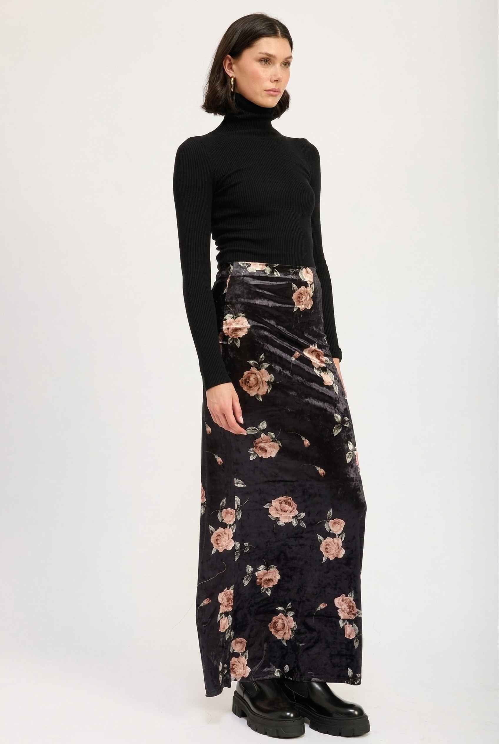 Model wearing Seraphina Skirt in Black Floral Stretch Velvet Column Maxi Skirt with sleek turtleneck and shiny loafers