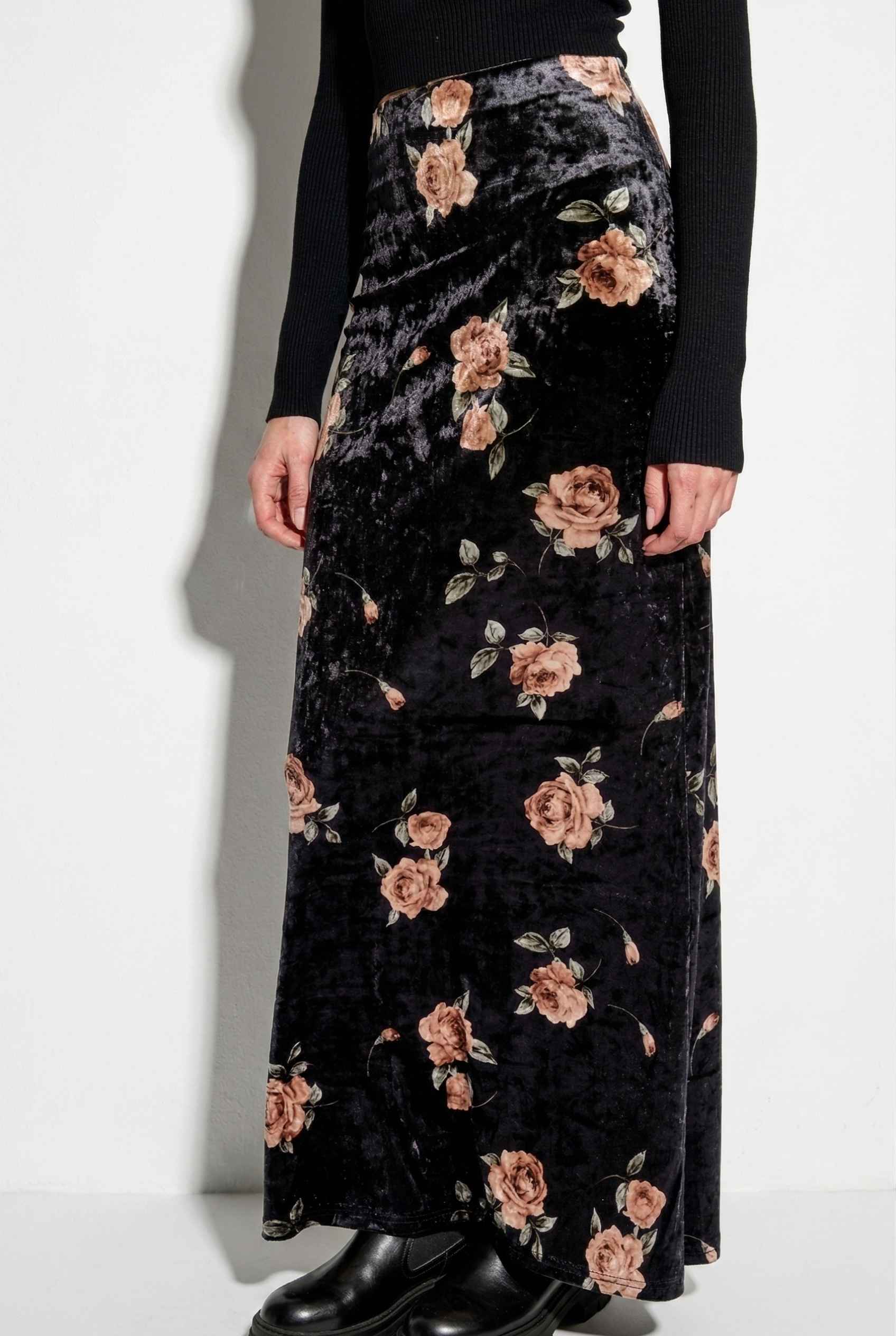 Model wearing Seraphina Skirt in Black Floral Stretch Velvet Column Maxi Skirt with sleek turtleneck and shiny loafers