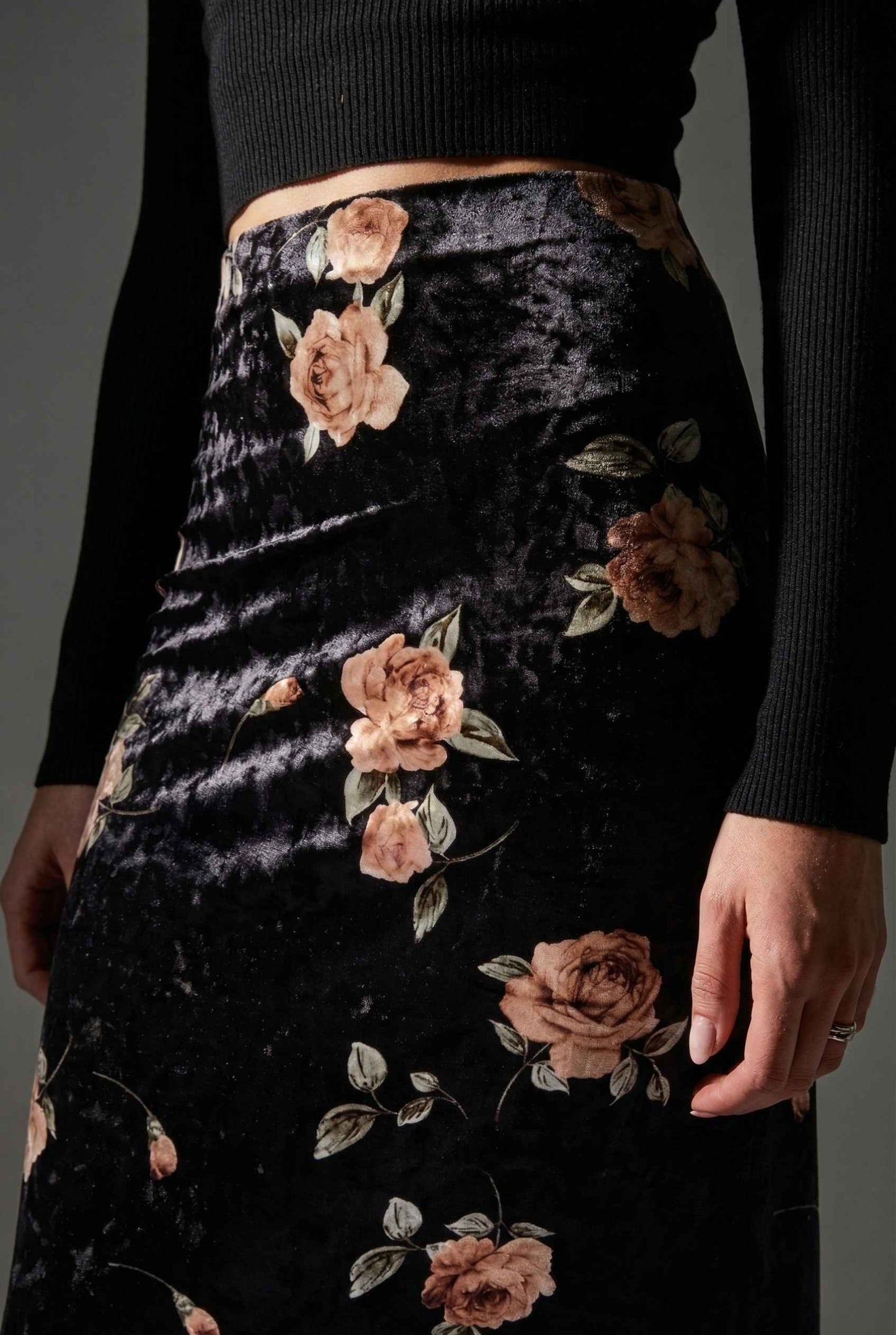 Model wearing Seraphina Skirt in Black Floral Stretch Velvet Column Maxi Skirt with sleek turtleneck close up vintage floral pattern