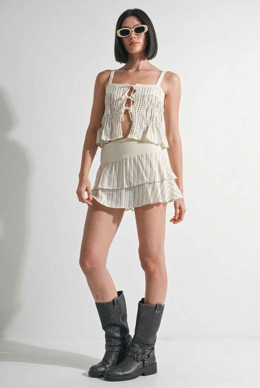 Model wearing Seraphina Skort in Cream Striped Tiered Ruffle Skort paired with matching tie-front cami tank and combat boots