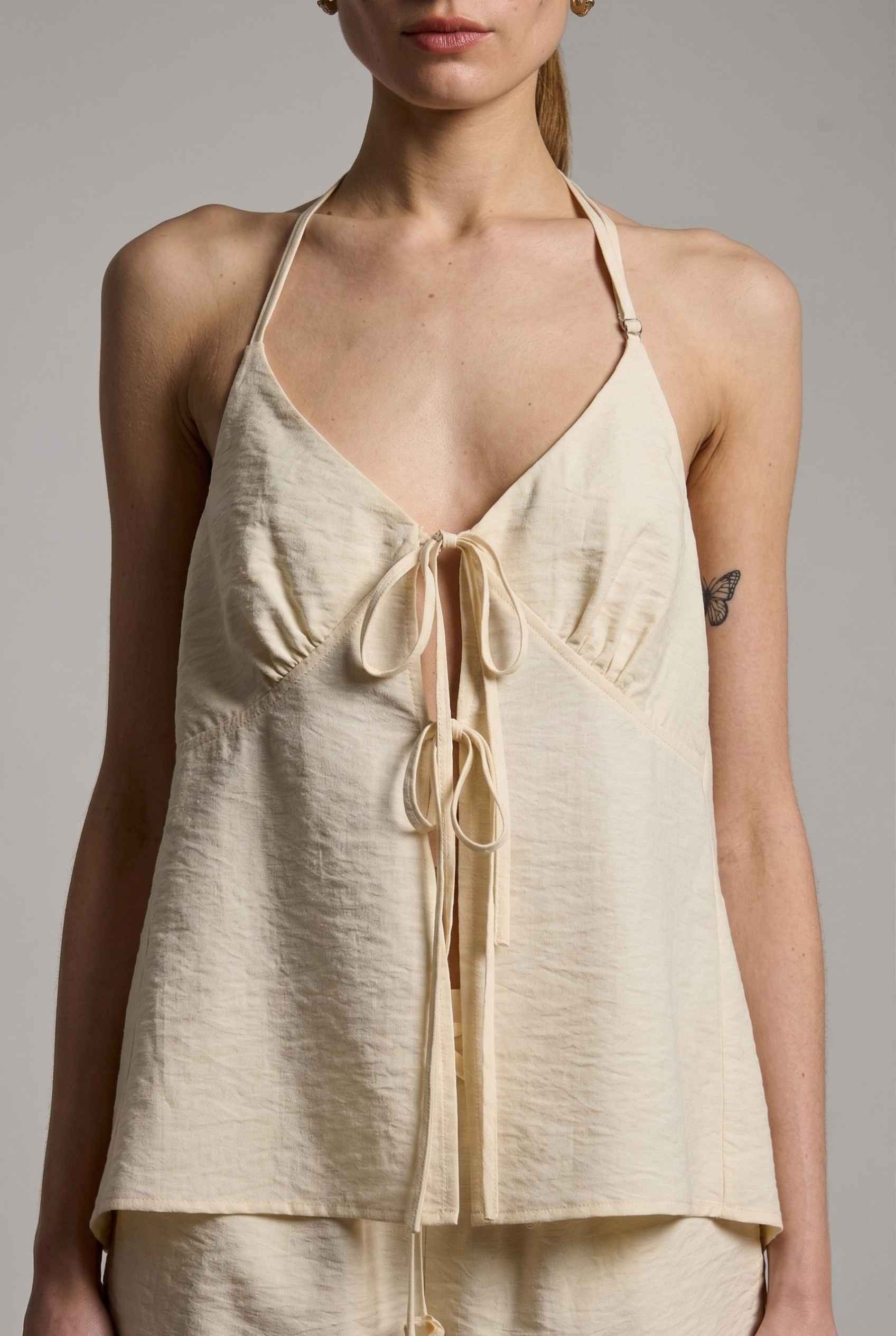 Sienna Top Cream Tie-Front V-Neck Halter Tank with a tie front on a plain background