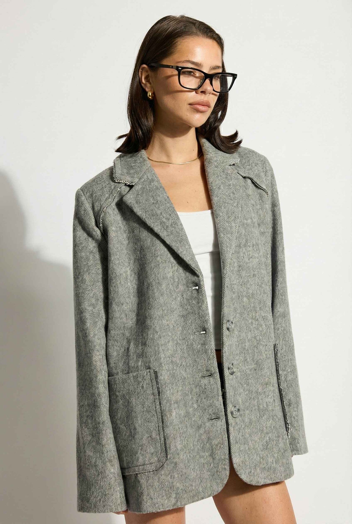 Model wearing The Silas Blazer | Grey Wool-Blend Blazer with Raw Hem Details with shorts