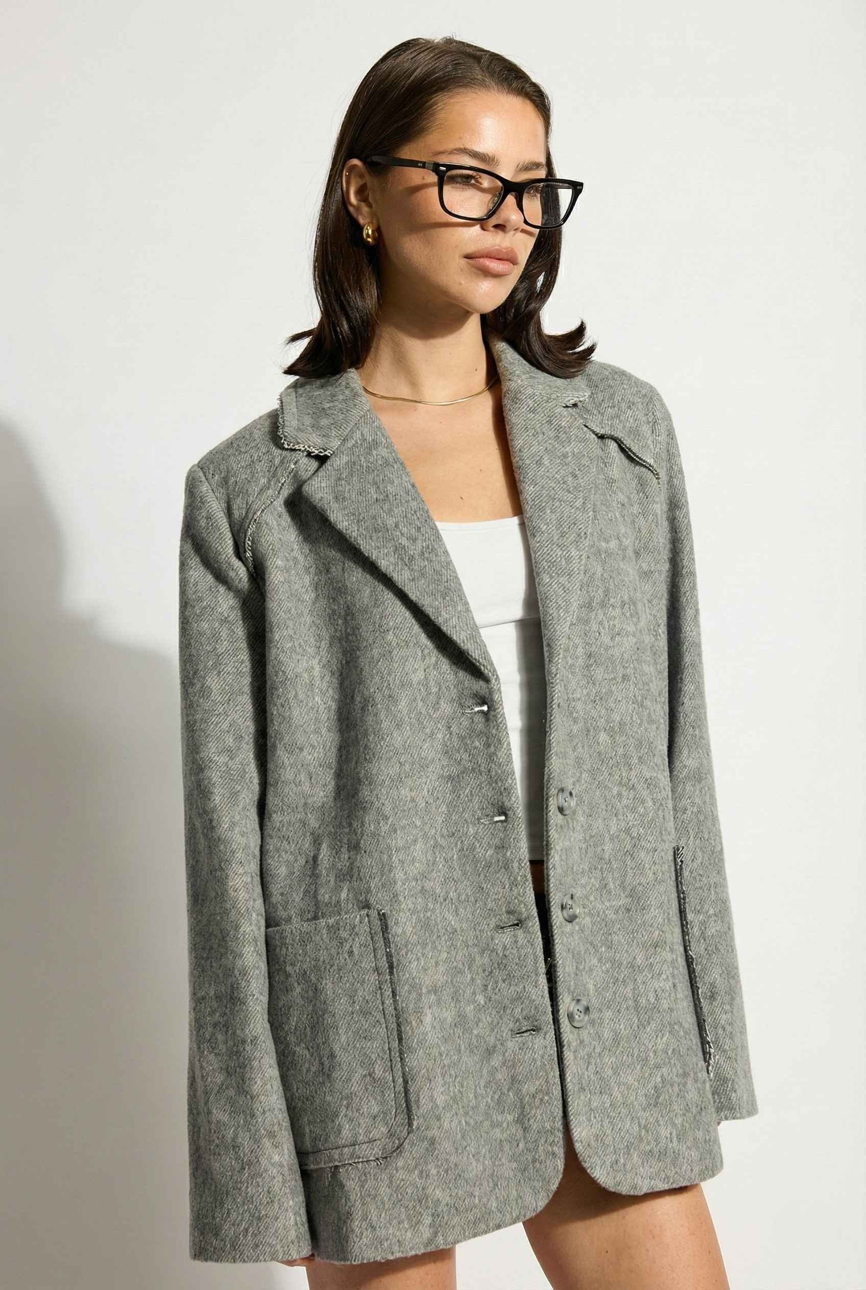 Model wearing The Silas Blazer | Grey Wool-Blend Blazer with Raw Hem Details with shorts