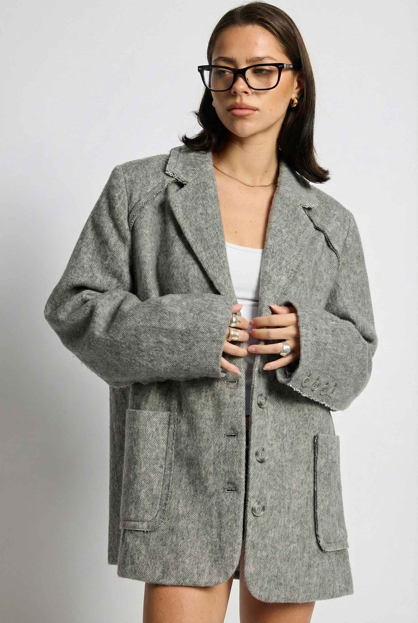 Model wearing The Silas Blazer | Grey Wool-Blend Blazer with Raw Hem Details with tank top