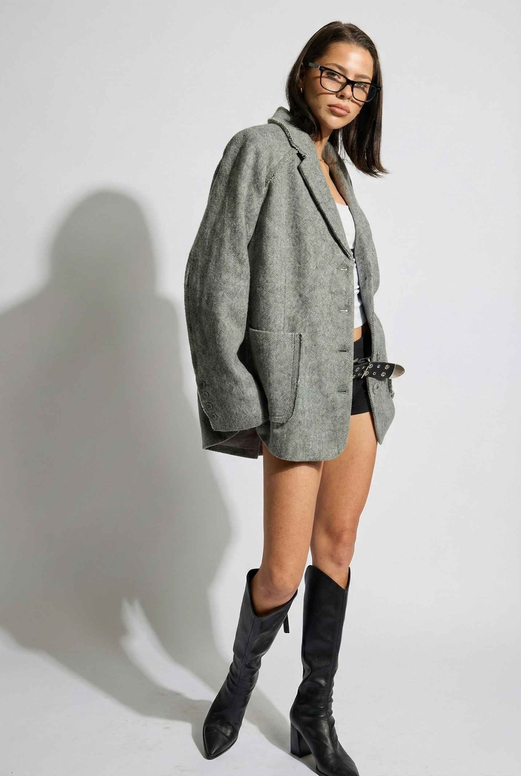 Model wearing The Silas Blazer | Grey Wool-Blend Blazer with Raw Hem Details with shorts and boots