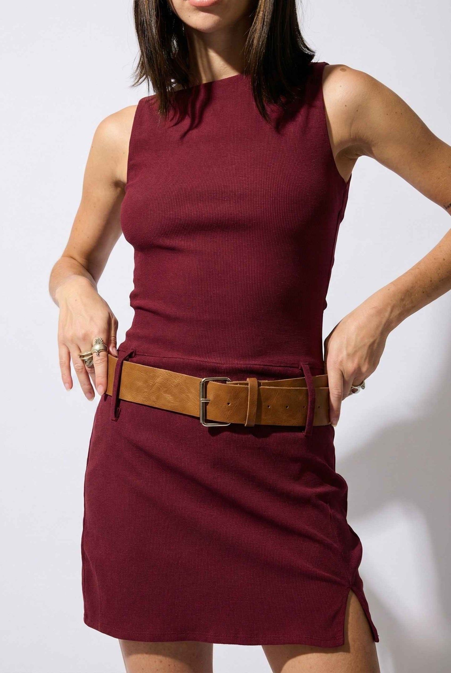 Woman wearing a Sloane Mini Burgundy Boat Neck Structured Knit Dress with a brown belt against a white background